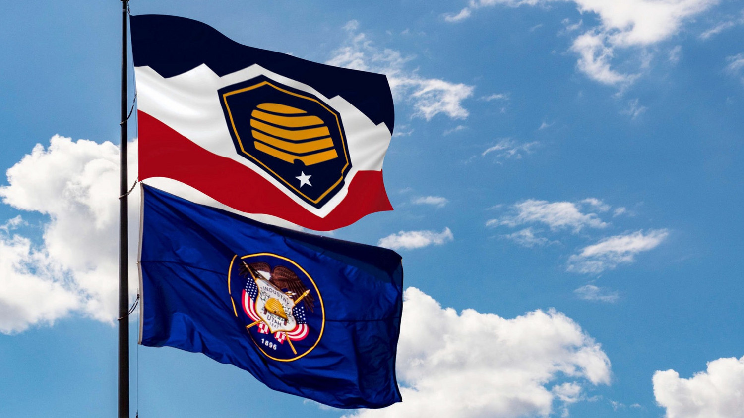 The image shows the flag that's to become Utah's official banner on March 9, on top. The flag on the bottom has been the state flag and would become the "historic state flag."