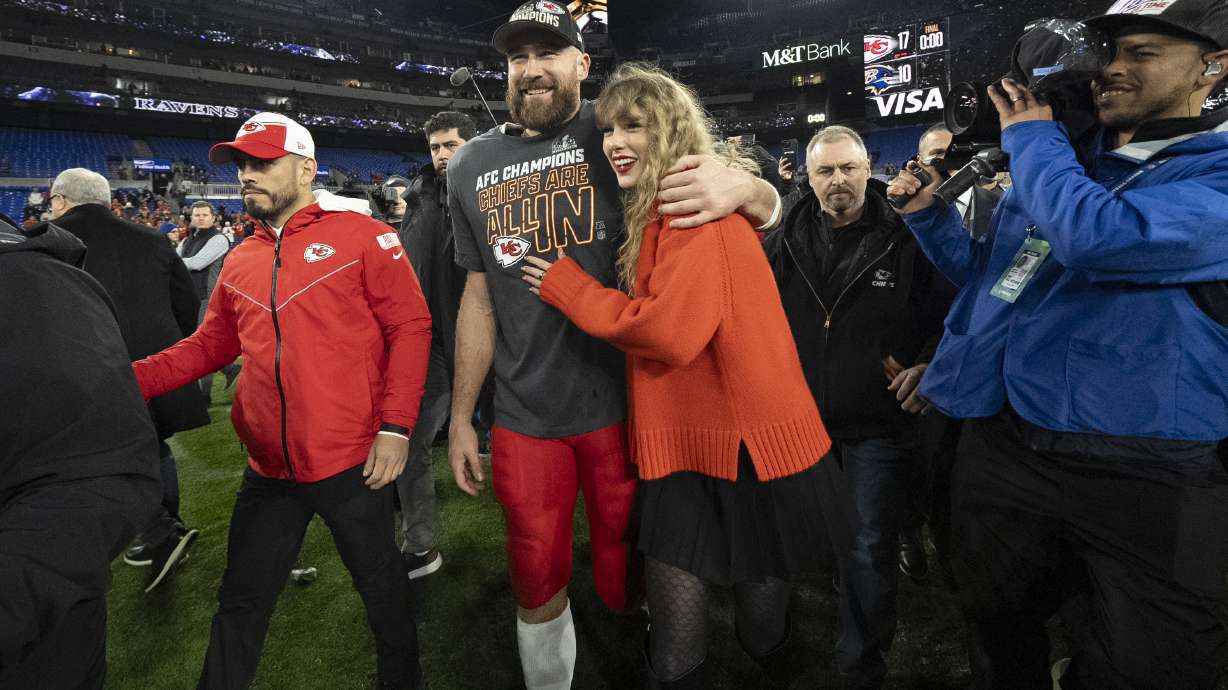 FILE - Kansas City Chiefs tight end Travis Kelce walks with Taylor Swift following the AFC Championship NFL football game between the Baltimore Ravens and the Kansas City Chiefs in Baltimore on Jan. 28, 2024. The Chiefs won 17-10.