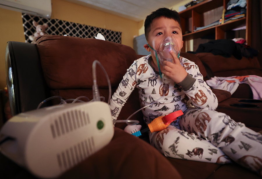 Ruben Mandujano, who has asthma and is autistic, uses a nebulizer with albuterol at his home near the Salton Sea and Mecca, California, on Thursday, Dec. 14, 2023. Ruben, 5, doesn’t like the nebulizer, as it often makes him throw up, but knows it is necessary when he is sick.