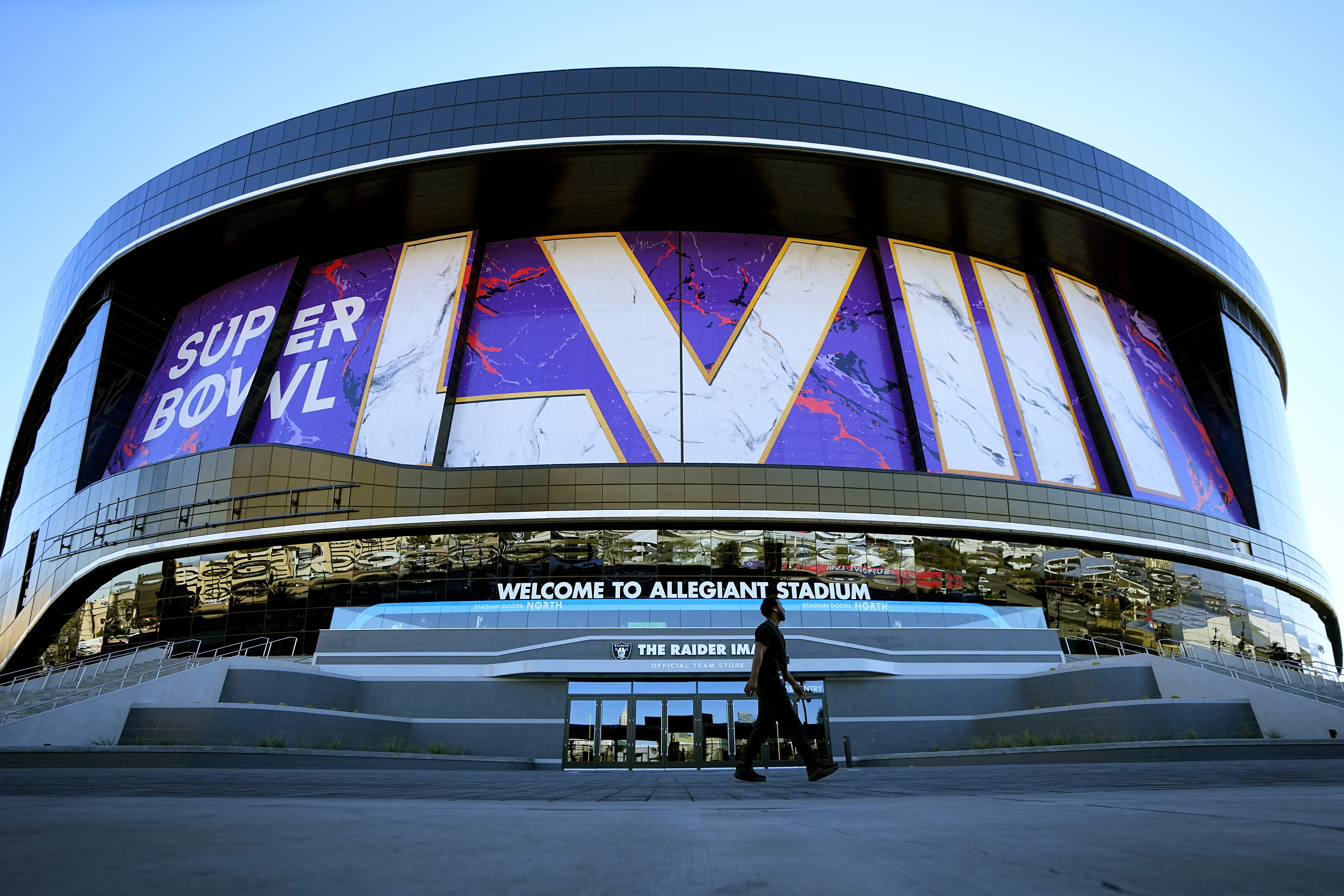 A worker walks in front of Allegiant Stadium in advance of Super Bowl 58, Tuesday, Jan. 30, 2024, in Las Vegas.