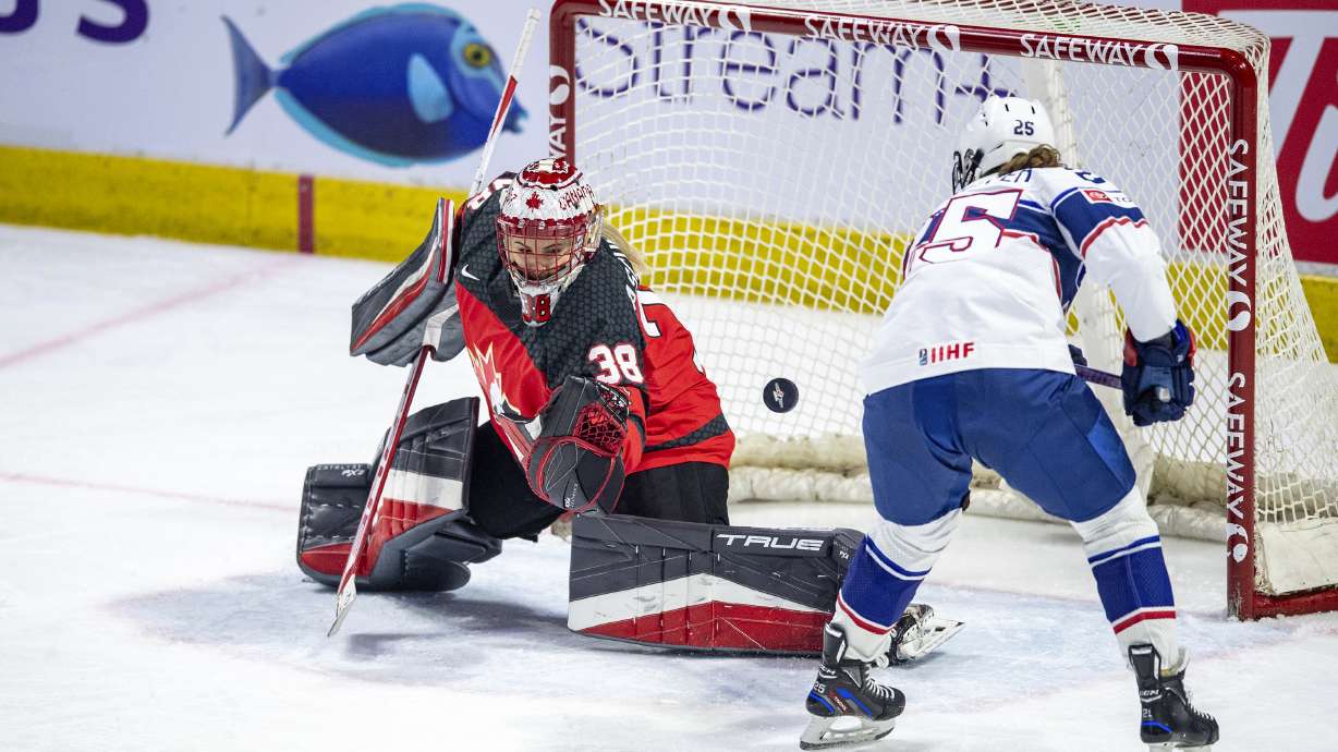 Canada goaltender Emerance Maschmeyer (38) stops a shot as United States' Alex Carpenter (25) looks for a rebound during the second period of a Rivalry Series hockey game Friday, Feb. 9, 2024, in Regina, Saskatchewan.