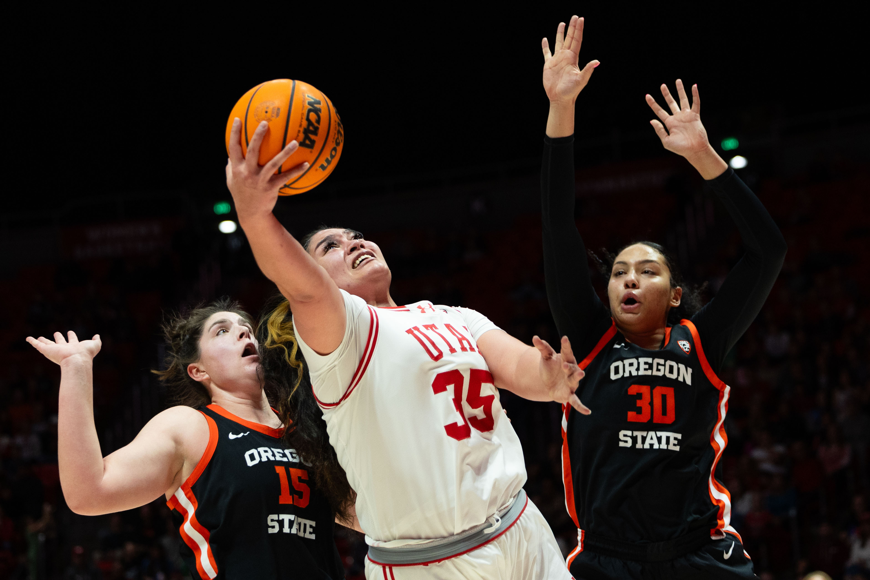 Utah Utes forward Alissa Pili (35) shoots the ball with Oregon State Beavers forward Raegan Beers (15) and Oregon State Beavers forward Timea Gardiner (30) on defense during the women’s college basketball game between the Utah Utes and the Oregon State Beavers at the Jon M. Huntsman Center in Salt Lake City on Friday, Feb. 9, 2024.