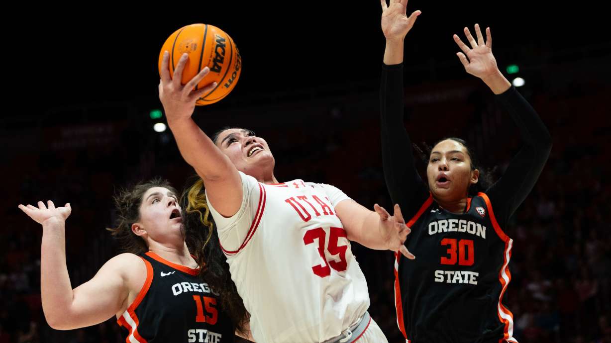 Utah Utes forward Alissa Pili (35) shoots the ball with Oregon State Beavers forward Raegan Beers (15) and Oregon State Beavers forward Timea Gardiner (30) on defense during the women’s college basketball game between the Utah Utes and the Oregon State Beavers at the Jon M. Huntsman Center in Salt Lake City on Friday, Feb. 9, 2024.