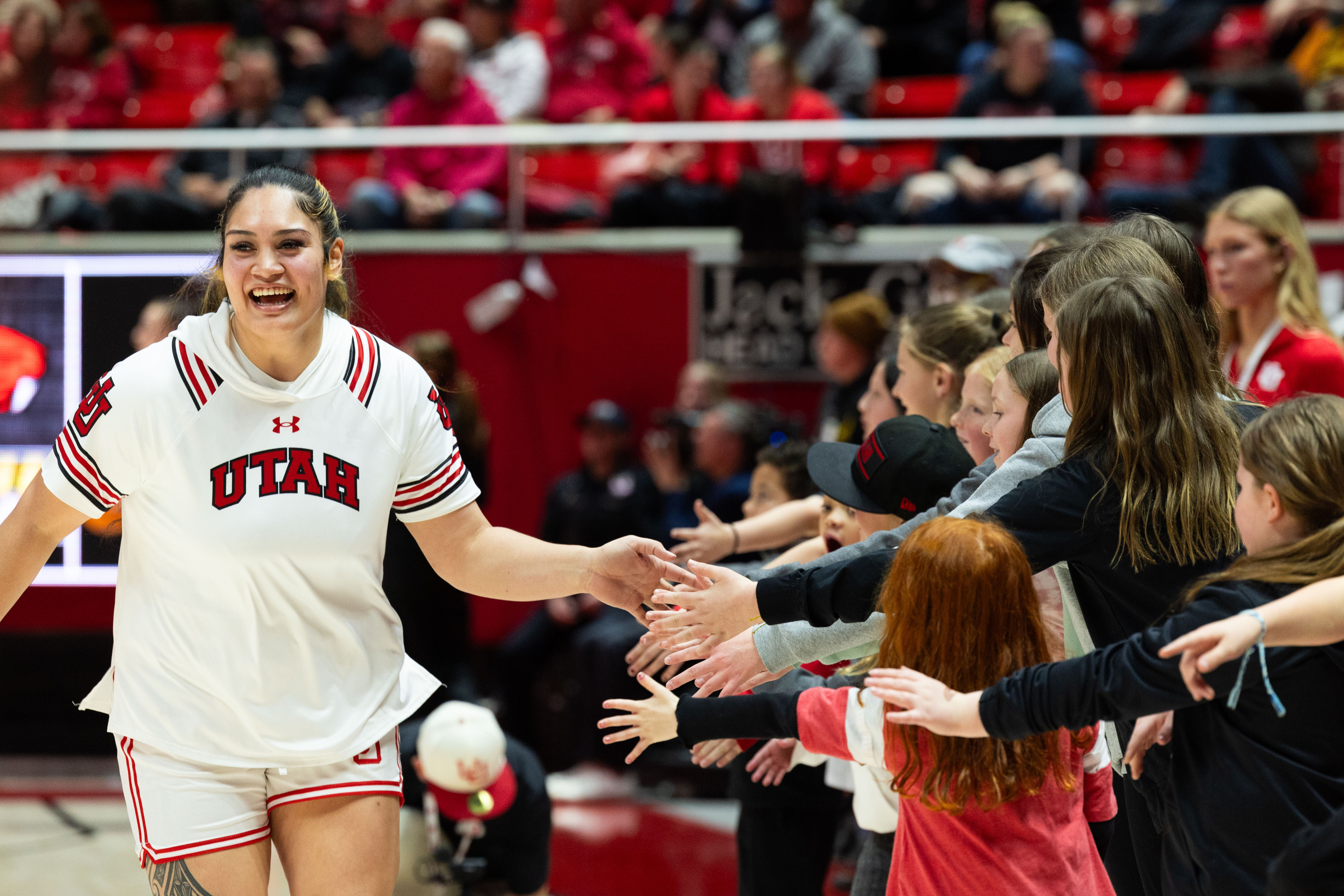 Utah Utes forward Alissa Pili (35) high-fives fans before the women’s college basketball game between the Utah Utes and the Oregon State Beavers at the Jon M. Huntsman Center in Salt Lake City on Friday, Feb. 9, 2024.