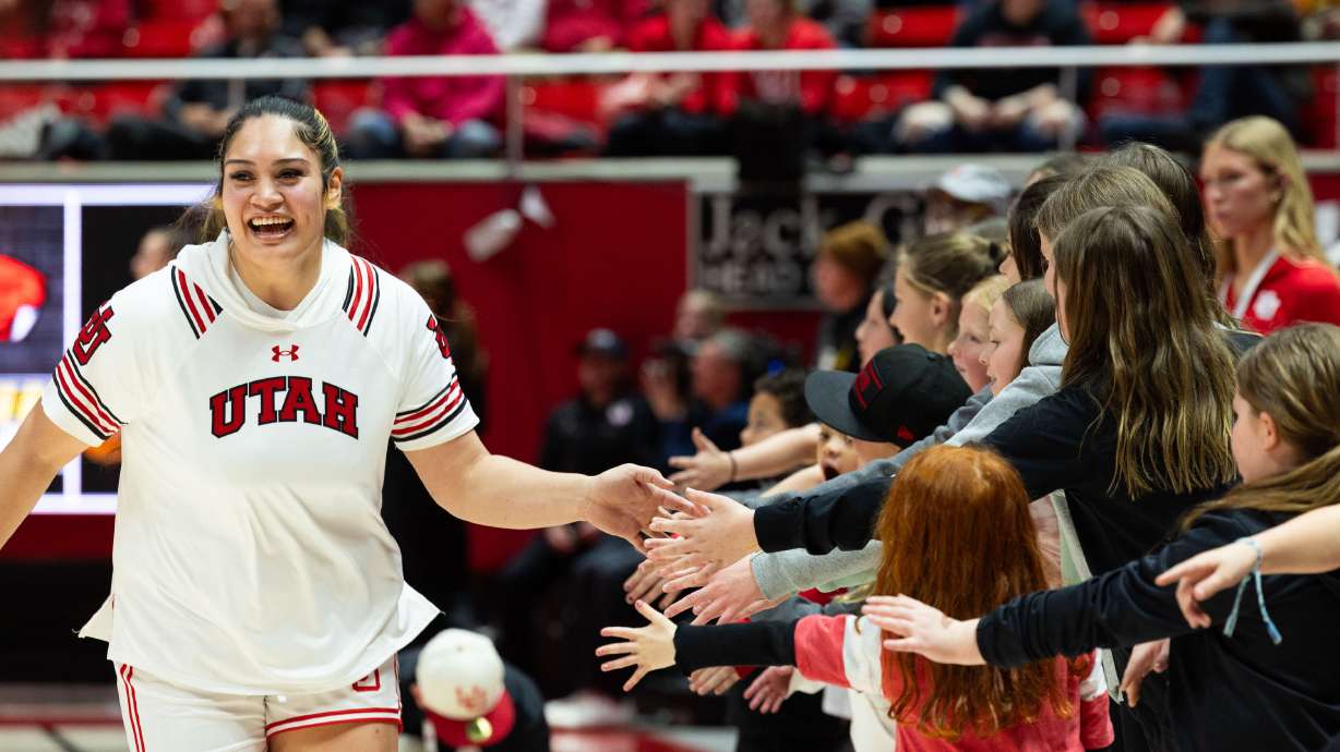 Utah Utes forward Alissa Pili (35) high-fives fans before the women’s college basketball game between the Utah Utes and the Oregon State Beavers at the Jon M. Huntsman Center in Salt Lake City on Friday, Feb. 9, 2024.