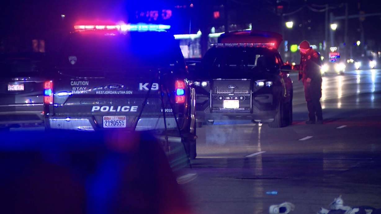 Police investigate the scene where a man was critically injured when he was hit by a car while trying to cross 7800 South near 3420 West in West Jordan on Friday night.