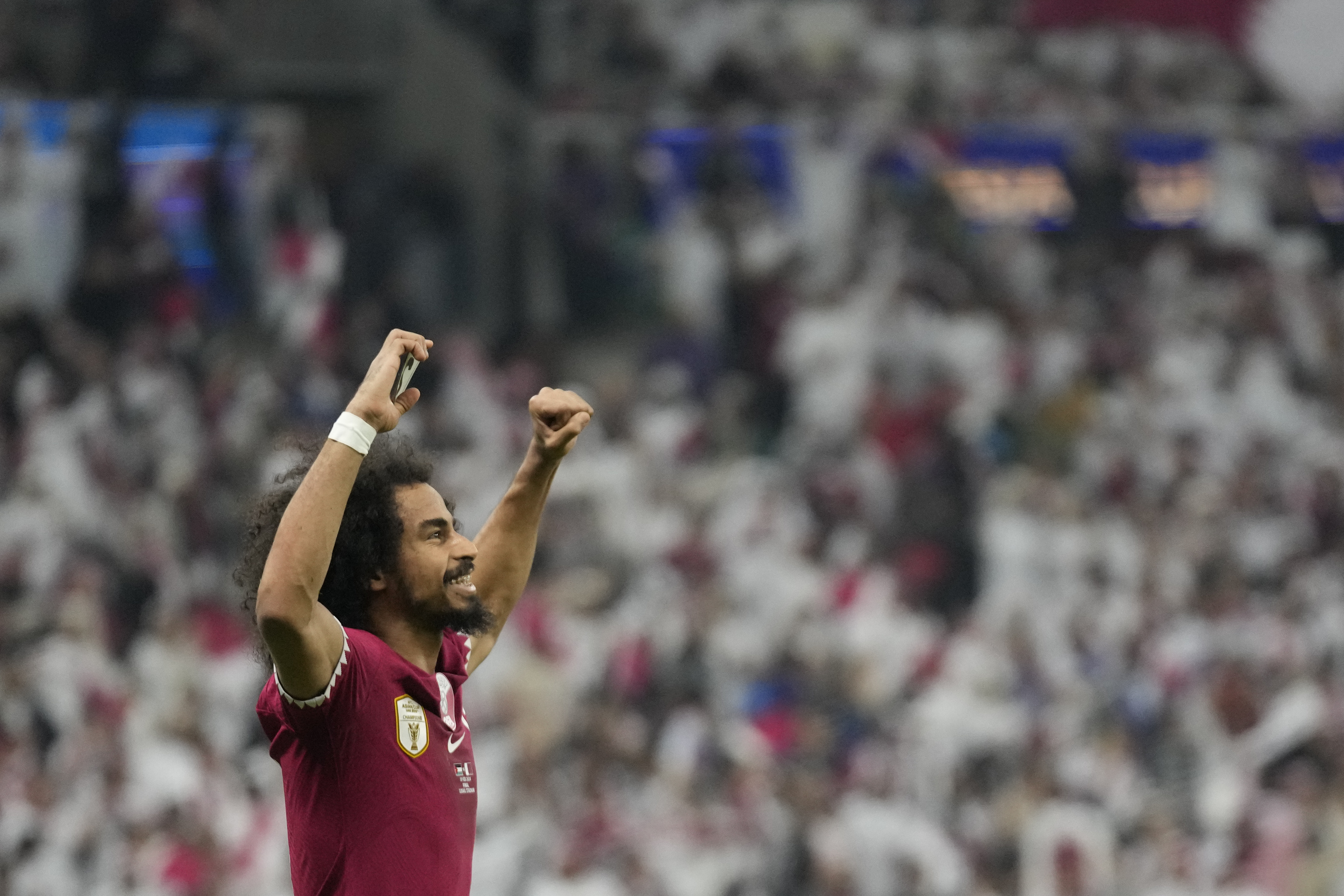 Qatar's Akram Afif celebrates after scoring his side's opening goal during the Asian Cup final soccer match between Qatar and Jordan at the Lusail Stadium in Lusail, Qatar, Saturday, Feb. 10, 2024.