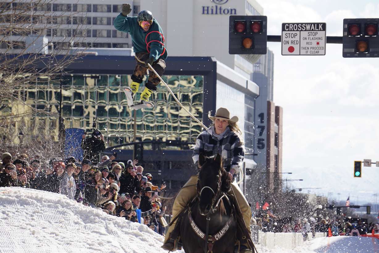 Marquise Young pulls a skier behind her horse Slim, during the Skijoring Utah exhibition in downtown Salt Lake City on Feb. 10, 2024.
