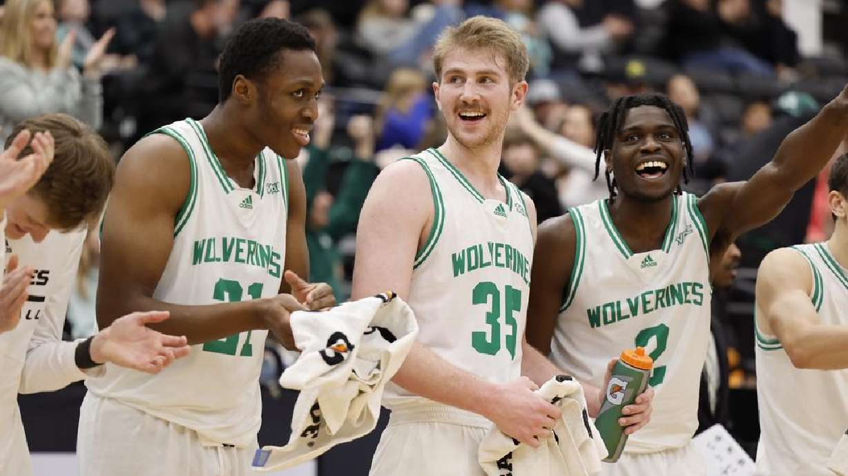 Nate Tshimanga (21), Ethan Potter (35), and K'Mani Doughty (2) celebrate during Utah Valley's victory over Abilene Christian Saturday.