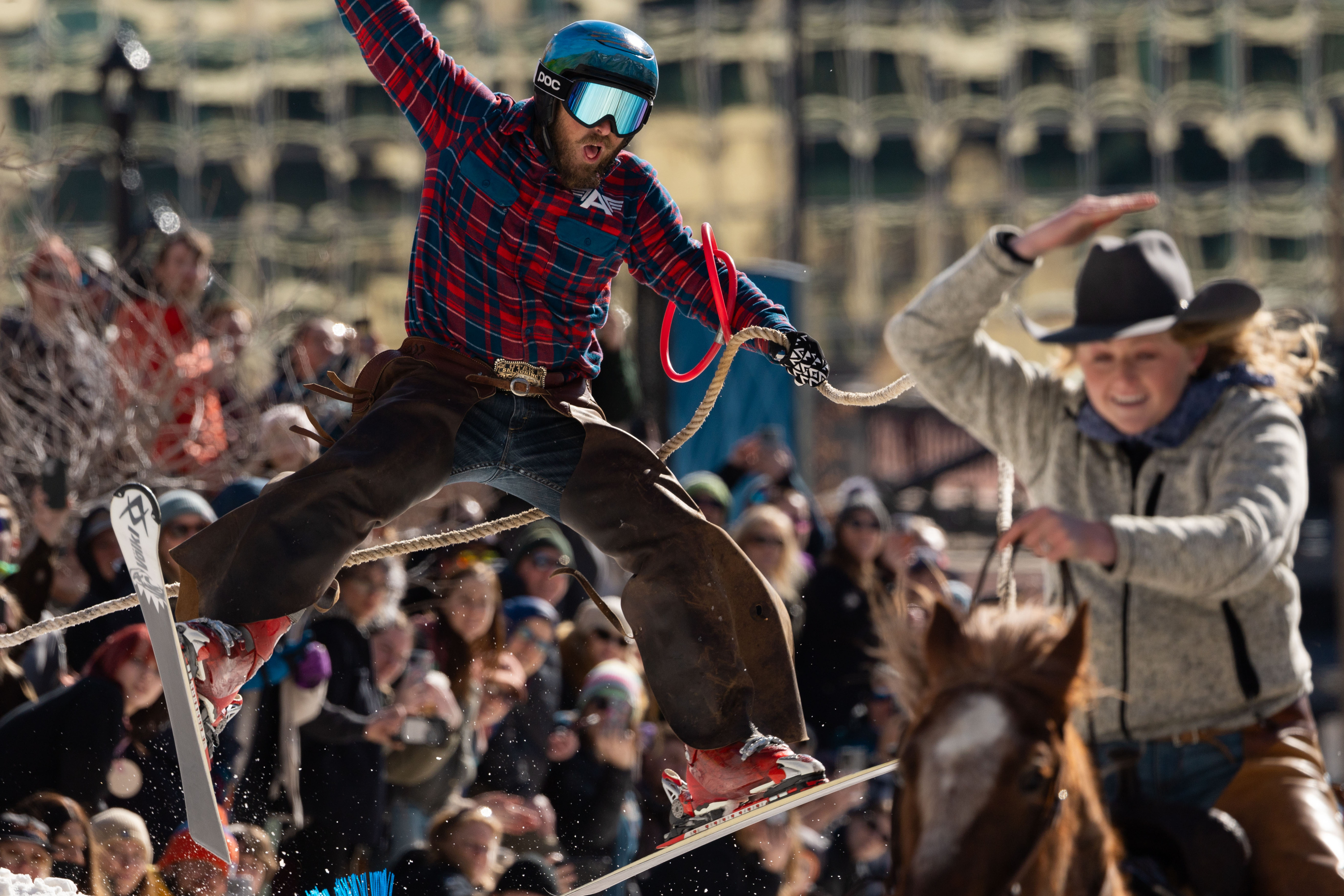 Scott Hoover skis behind Emalee Fowles riding Cheddar in a skijoring event, part of the Salt Lake Winter Roundup, on West Temple in downtown Salt Lake City on Saturday.