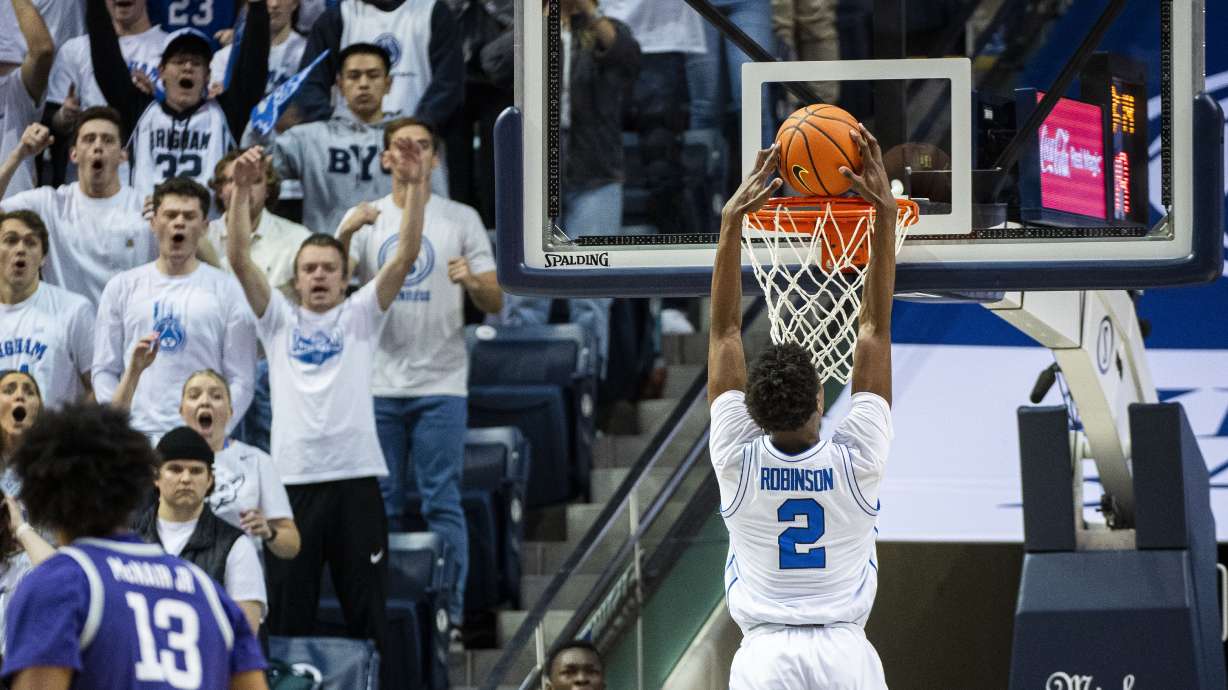 BYU guard Jaxson Robinson (2) dunks against Kansas State during the first half of an NCAA college basketball game Saturday, Feb. 10, 2024, in Provo, Utah.