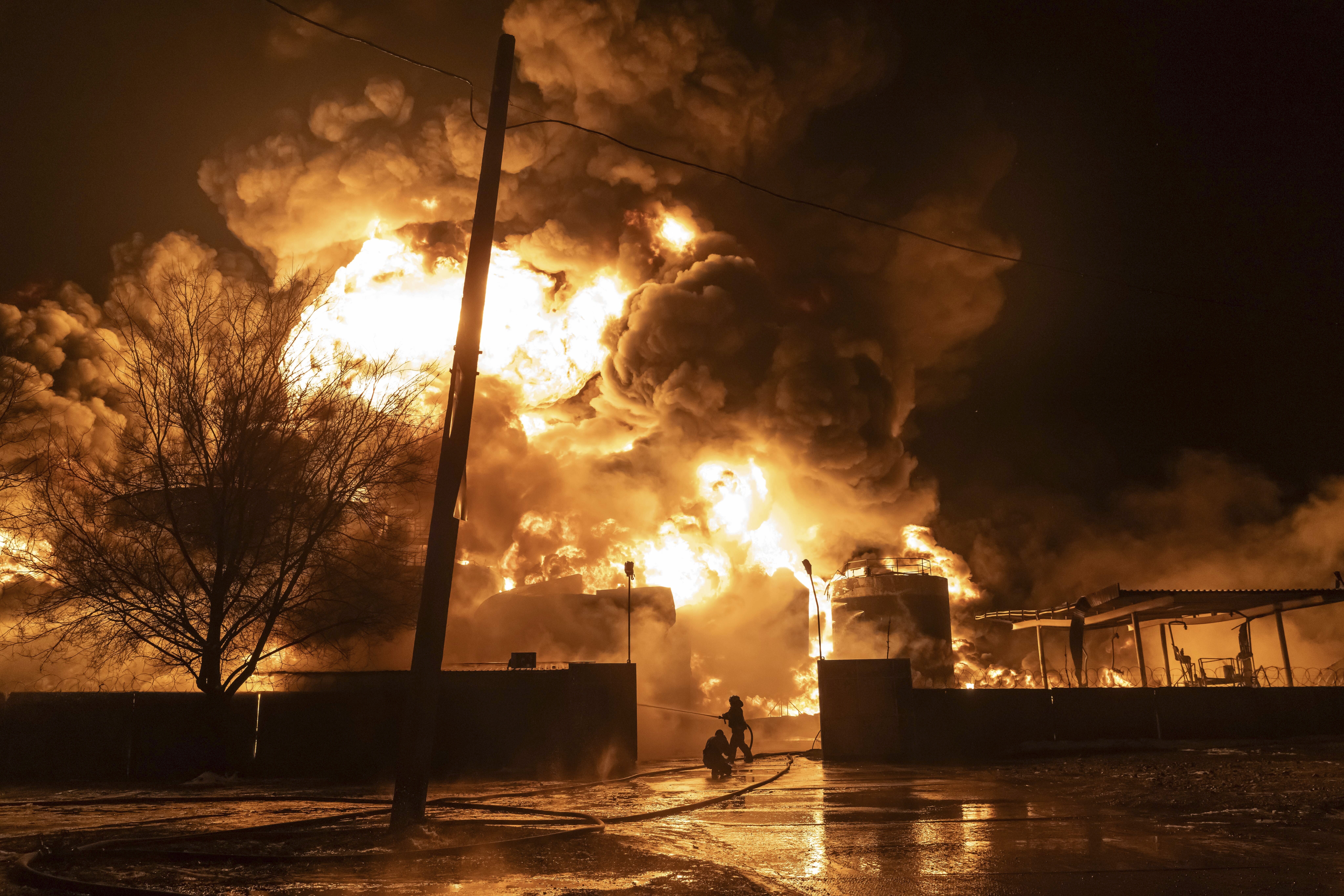 Firefighters extinguish a fire after a Russian attack on a residential neighborhood in Kharkiv, Ukraine, Saturday.