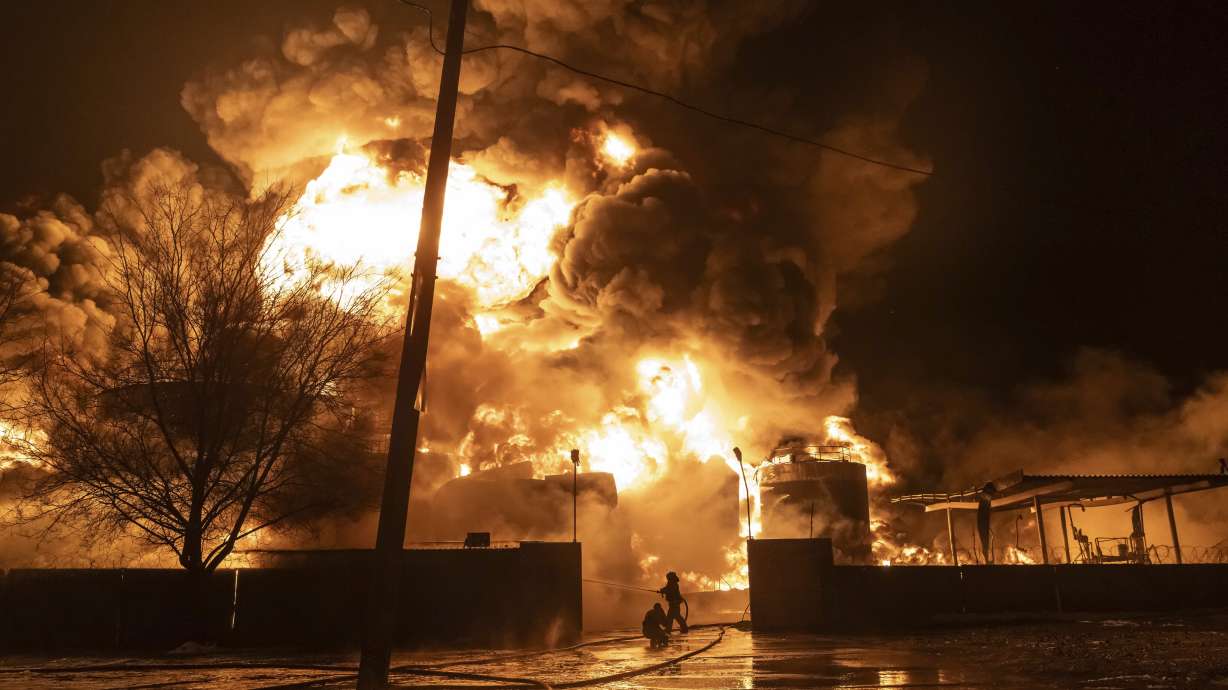 Firefighters extinguish a fire after a Russian attack on a residential neighborhood in Kharkiv, Ukraine, Saturday.
