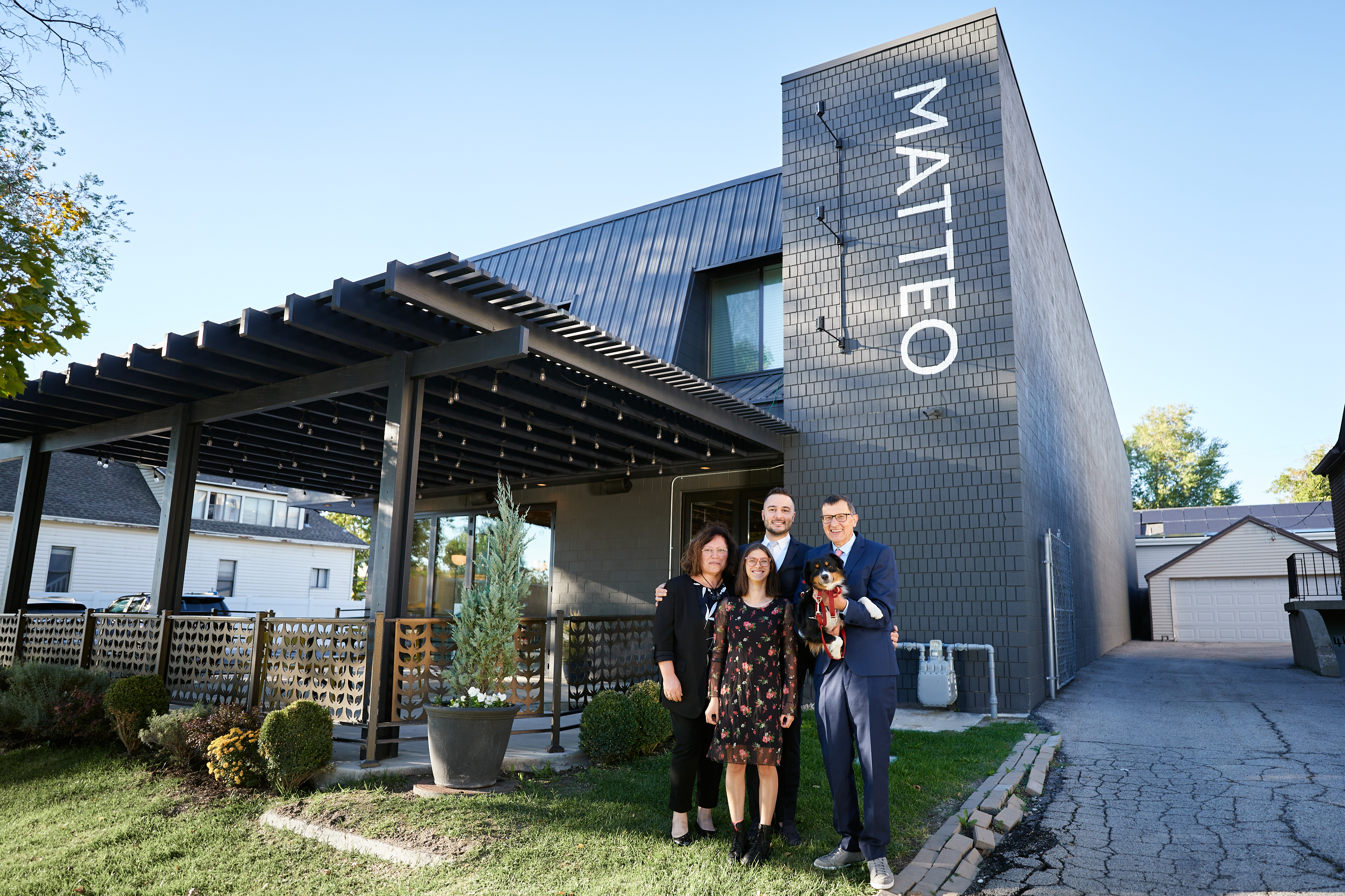 Matteo Sogne and his family pose in front of Matteo Ristorante Italiano