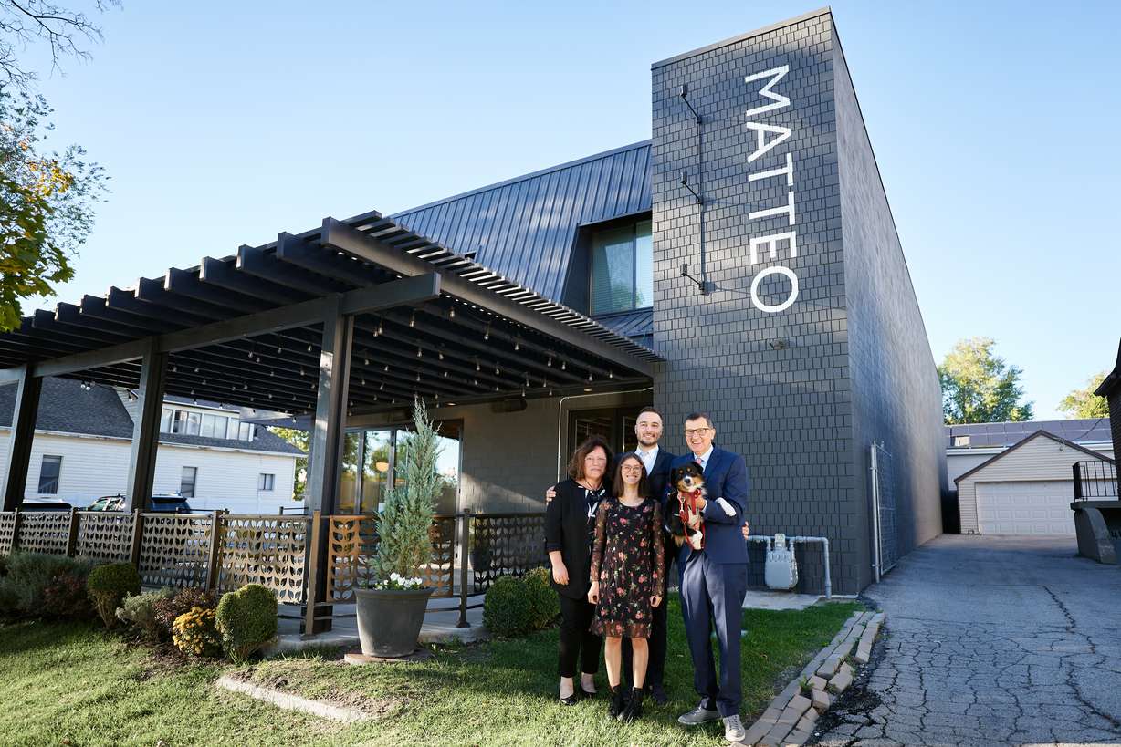Matteo Sogne and his family pose in front of Matteo Ristorante Italiano