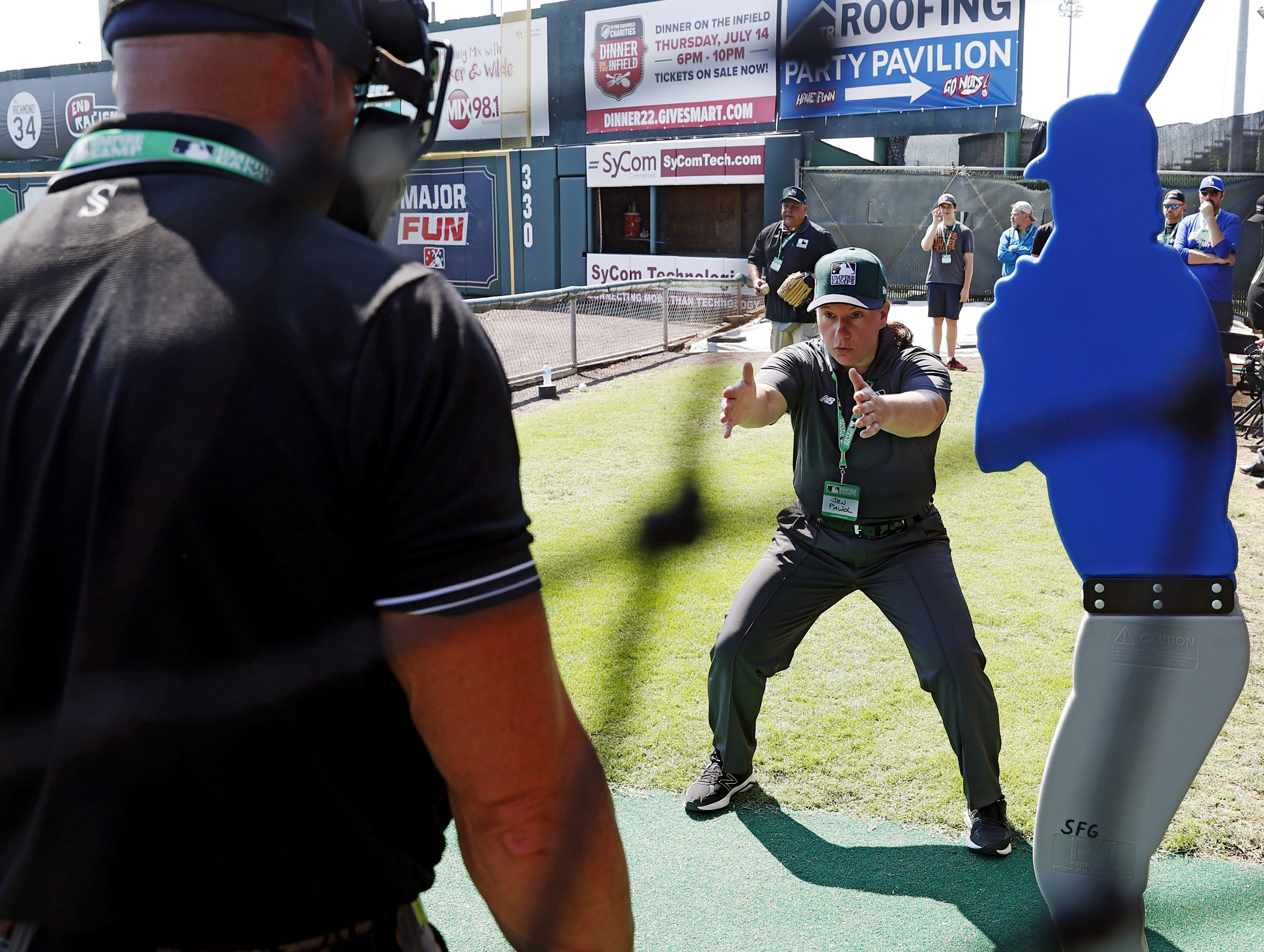FILE - Umpire Jen Pawol, front right, works with students during MLB baseball umpire camp at The Diamond in Richmond, Va., June 25, 2022. Pawol is on the verge of becoming Major League Baseball’s first woman umpire. 