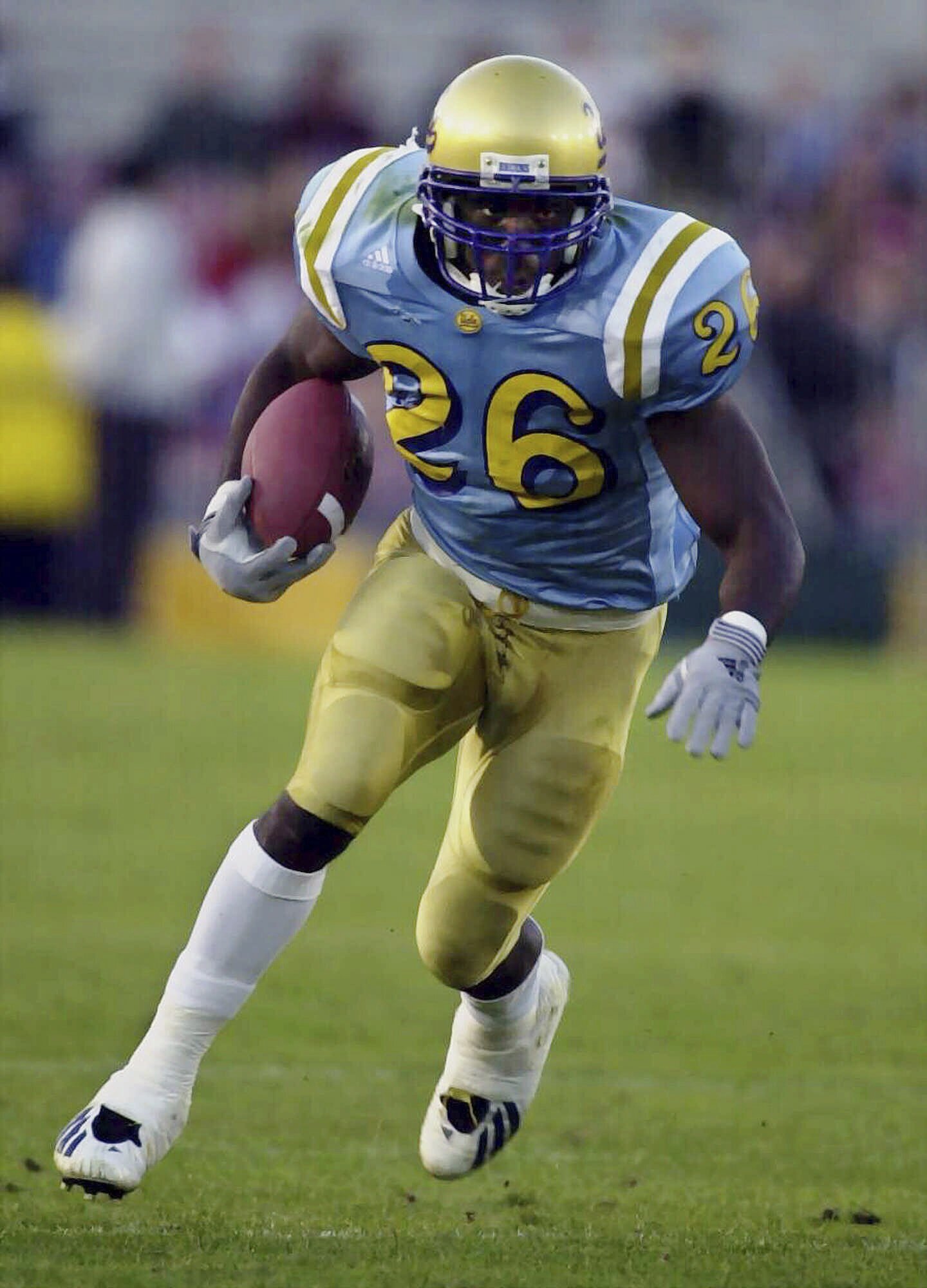 FILE - UCLA's DeShaun Foster looks for an opening against Stanford during the second quarter at the Rose Bowl in Pasadena, Calif., Saturday, Nov. 4, 2000. Former UCLA great DeShaun Foster was named head coach on Monday, Feb. 12, 2024, to take over the program after Chip Kelly left to become offensive coordinator at Ohio State. 