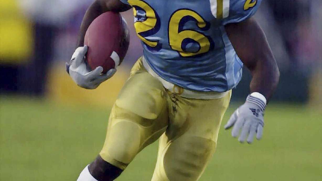 FILE - UCLA's DeShaun Foster looks for an opening against Stanford during the second quarter at the Rose Bowl in Pasadena, Calif., Saturday, Nov. 4, 2000. Former UCLA great DeShaun Foster was named head coach on Monday, Feb. 12, 2024, to take over the program after Chip Kelly left to become offensive coordinator at Ohio State.