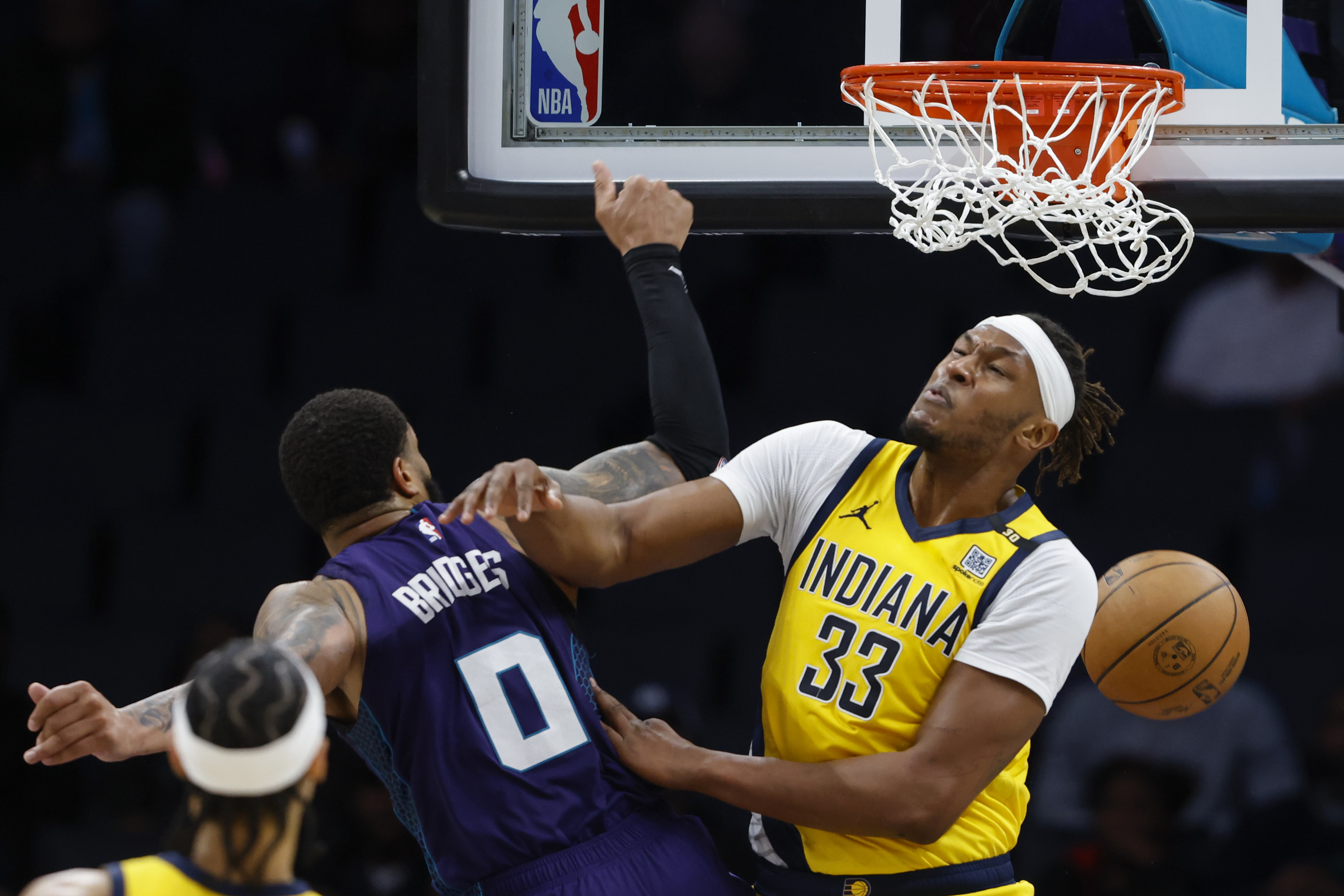 Charlotte Hornets forward Miles Bridges (0) dunks over Indiana Pacers center Myles Turner (33) during the second half of an NBA basketball game in Charlotte, N.C., Monday, Feb. 12, 2024. 