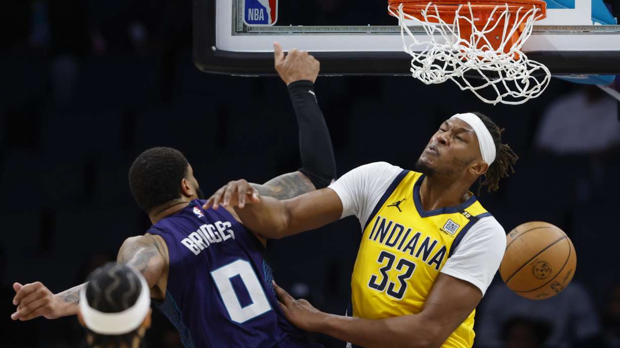 Charlotte Hornets forward Miles Bridges (0) dunks over Indiana Pacers center Myles Turner (33) during the second half of an NBA basketball game in Charlotte, N.C., Monday, Feb. 12, 2024.