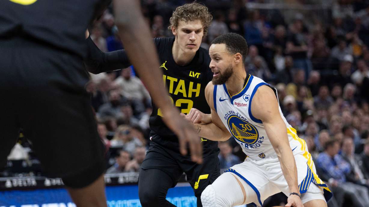 Utah Jazz forward Lauri Markkanen (23) defends against Golden State Warriors guard Stephen Curry (30) during the first half of a game at the Delta Center in Salt Lake City on Monday, Feb. 12, 2024.