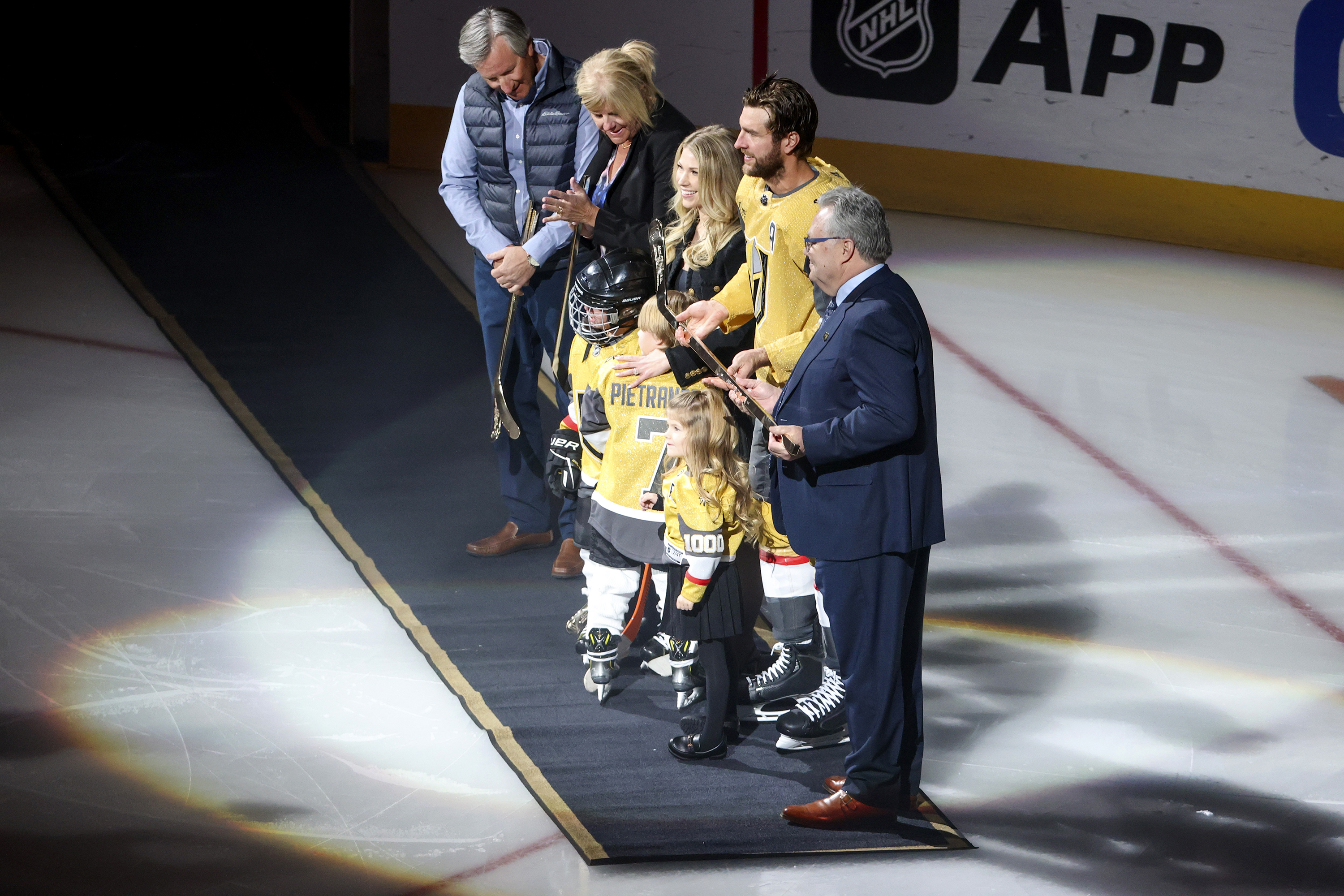 Vegas Golden Knights defenseman Alex Pietrangelo (7) is presented with a golden hockey stick honoring his 1000th NHL game by Golden Knights general manager Kelly McCrimmon, right, during a ceremony prior to an NHL hockey game against the Minnesota Wild, Monday, Feb. 12, 2024, in Las Vegas. 