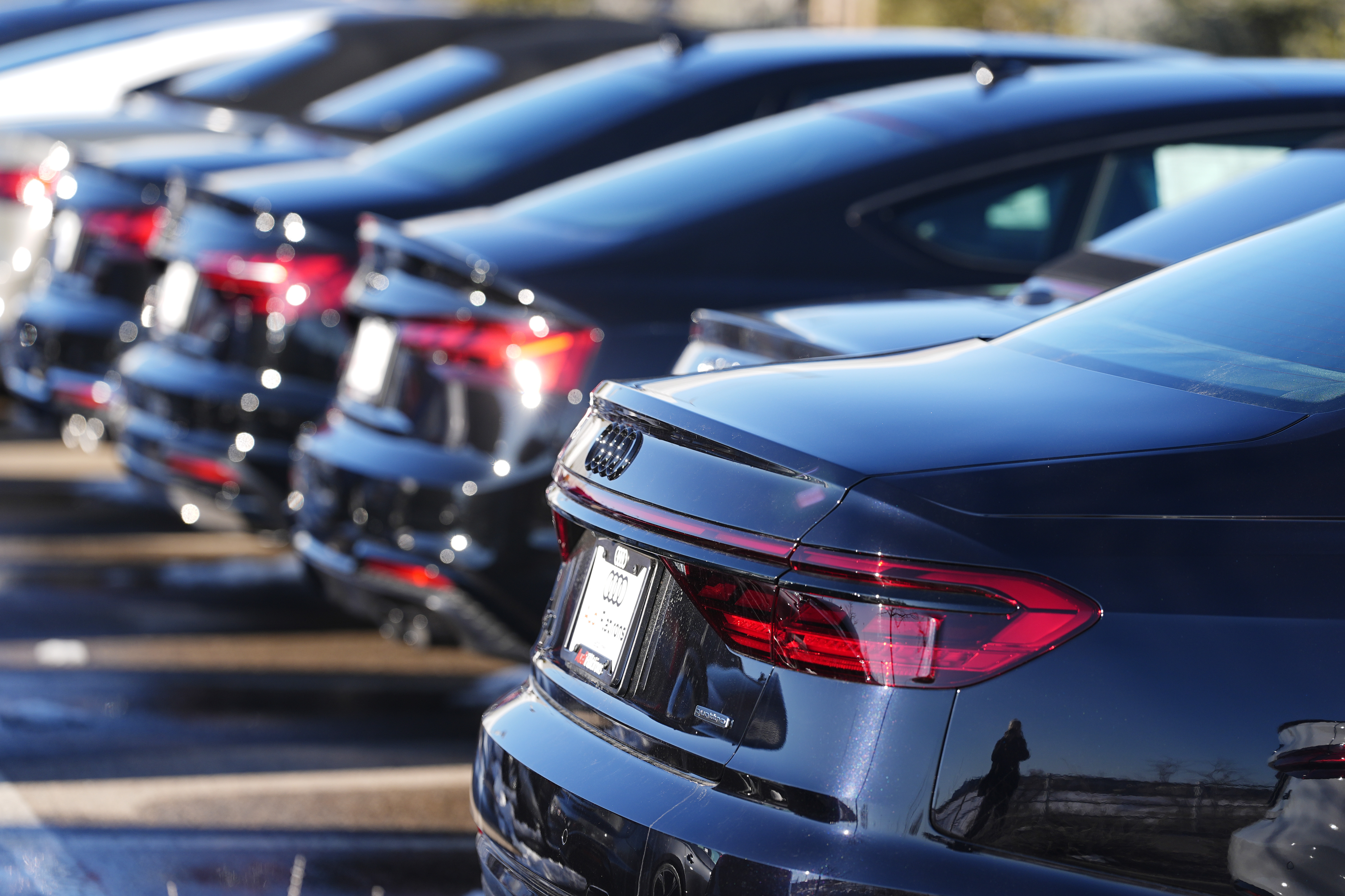Unsold 2023 sedans sit in a long row at an Audi dealership Feb. 11, in Broomfield, Colo. On Tuesday, the Labor Department issued its report on inflation at the consumer level in January.