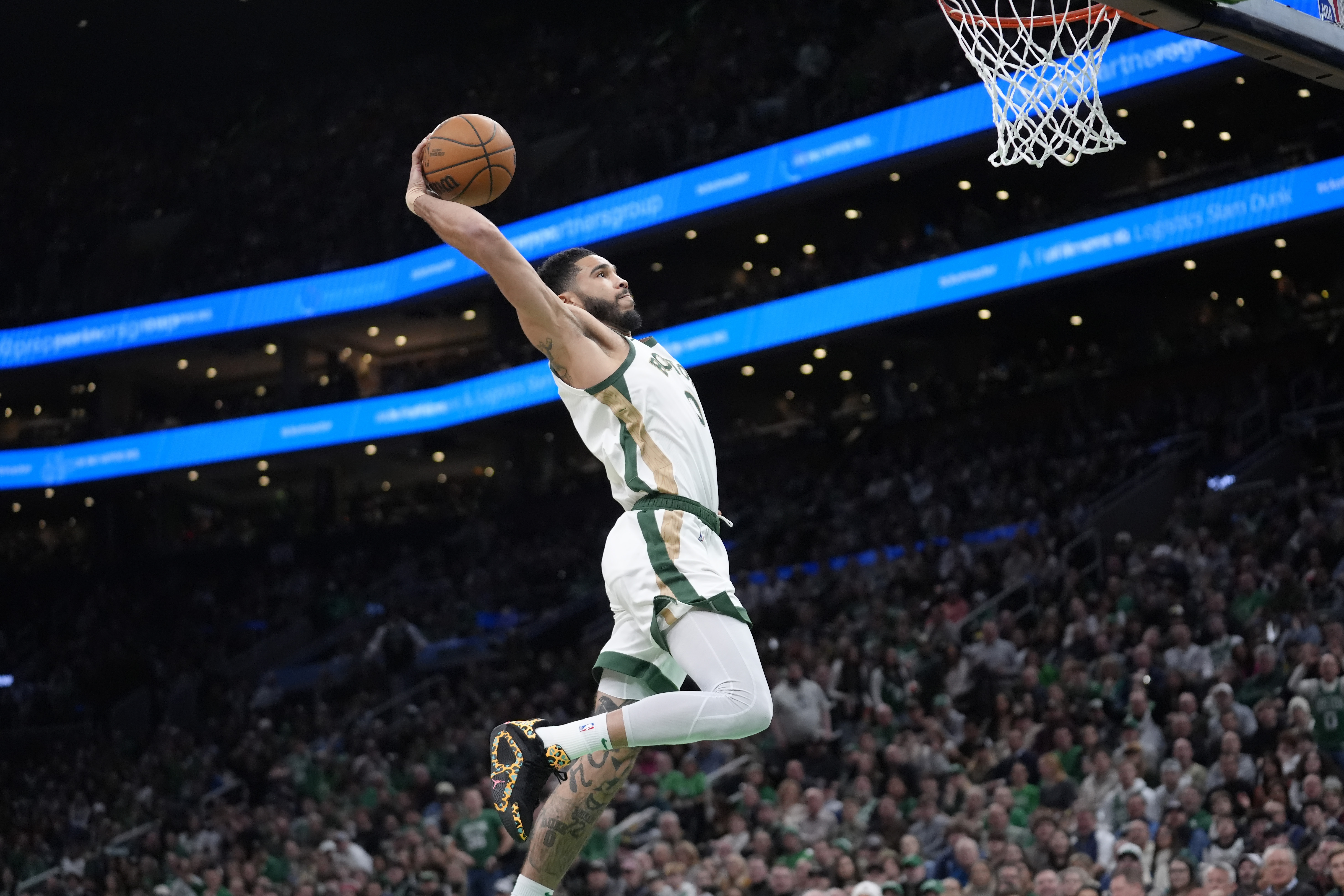 Boston Celtics forward Jayson Tatum (0) dunks to score in the second half of an NBA basketball game against the Memphis Grizzlies, Sunday, Feb. 4, 2024, in Boston. 