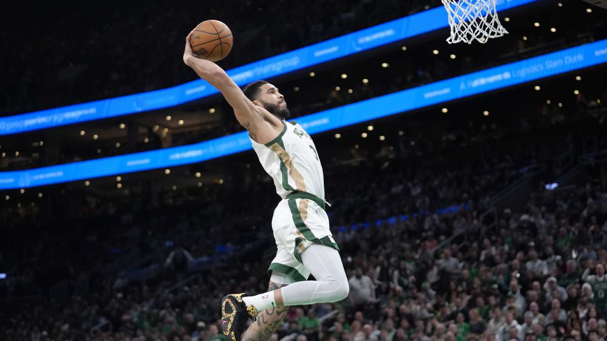 Boston Celtics forward Jayson Tatum (0) dunks to score in the second half of an NBA basketball game against the Memphis Grizzlies, Sunday, Feb. 4, 2024, in Boston.
