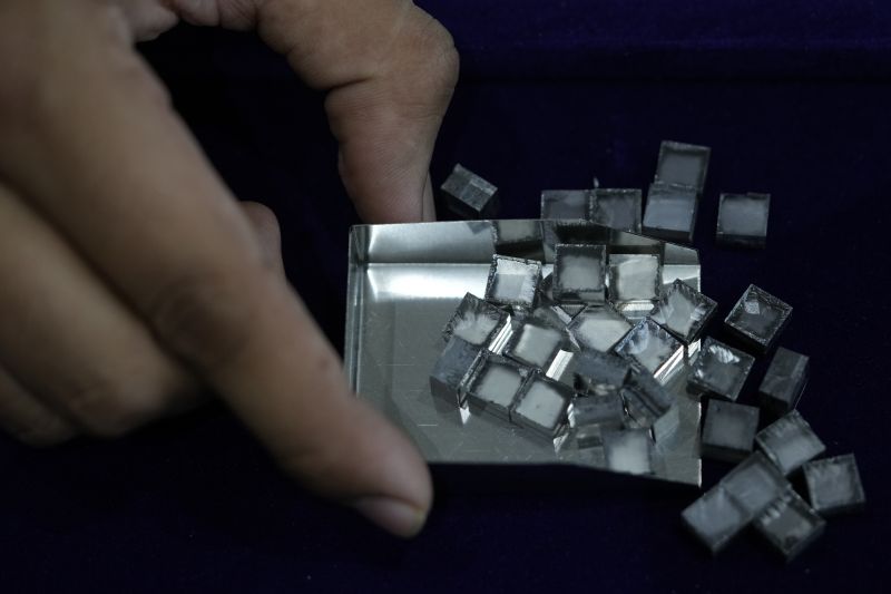 A man collects uncut lab-grown diamonds at Greenlab Diamonds, in Surat, India, Feb. 5. Diamonds, whether lab-grown or natural, are chemically identical and entirely made out of carbon.
