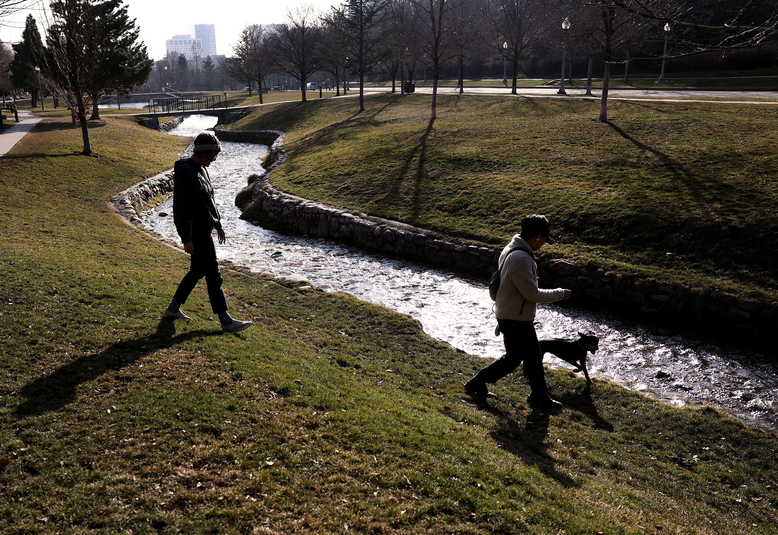 Daela Taeoalii-Tipton and Trung Tham, of Salt Lake City, walk near City Creek as it flows through Memory Grove in Salt Lake City on Jan. 20, 2022. City leaders say they are implementing changes after a recent water audit underscored inefficiencies.