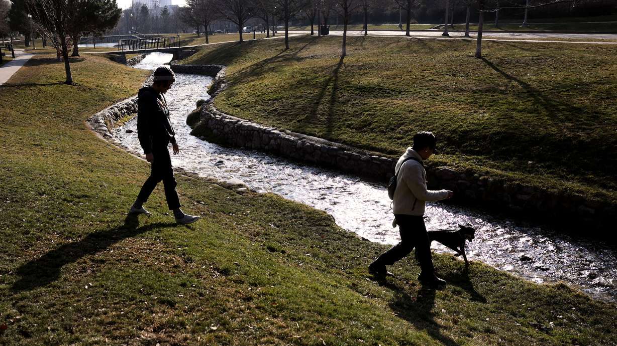 Daela Taeoalii-Tipton and Trung Tham, of Salt Lake City, walk near City Creek as it flows through Memory Grove in Salt Lake City on Jan. 20, 2022. City leaders say they are implementing changes after a recent water audit underscored inefficiencies.