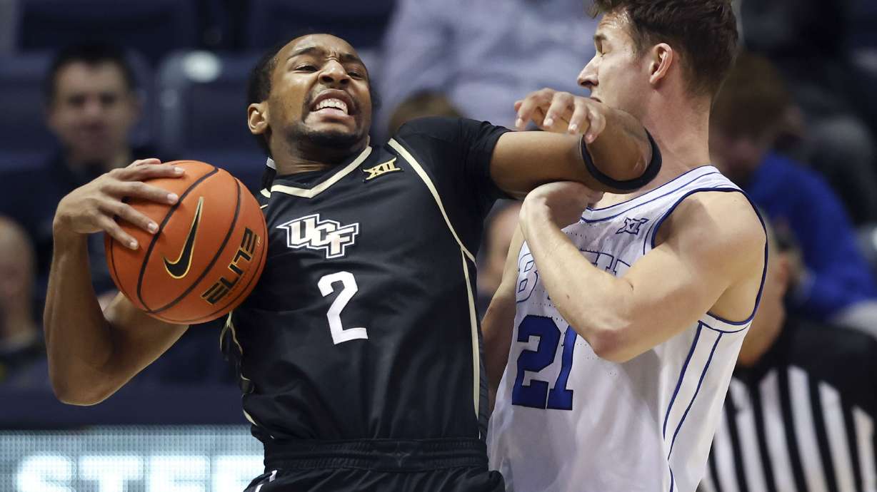 UCF guard Shemarri Allen (2) fouls Brigham Young guard Trevin Knell (21) at the Marriott Center in Provo on Tuesday, Feb. 13, 2024. Allen was charged with a flagrant foul.