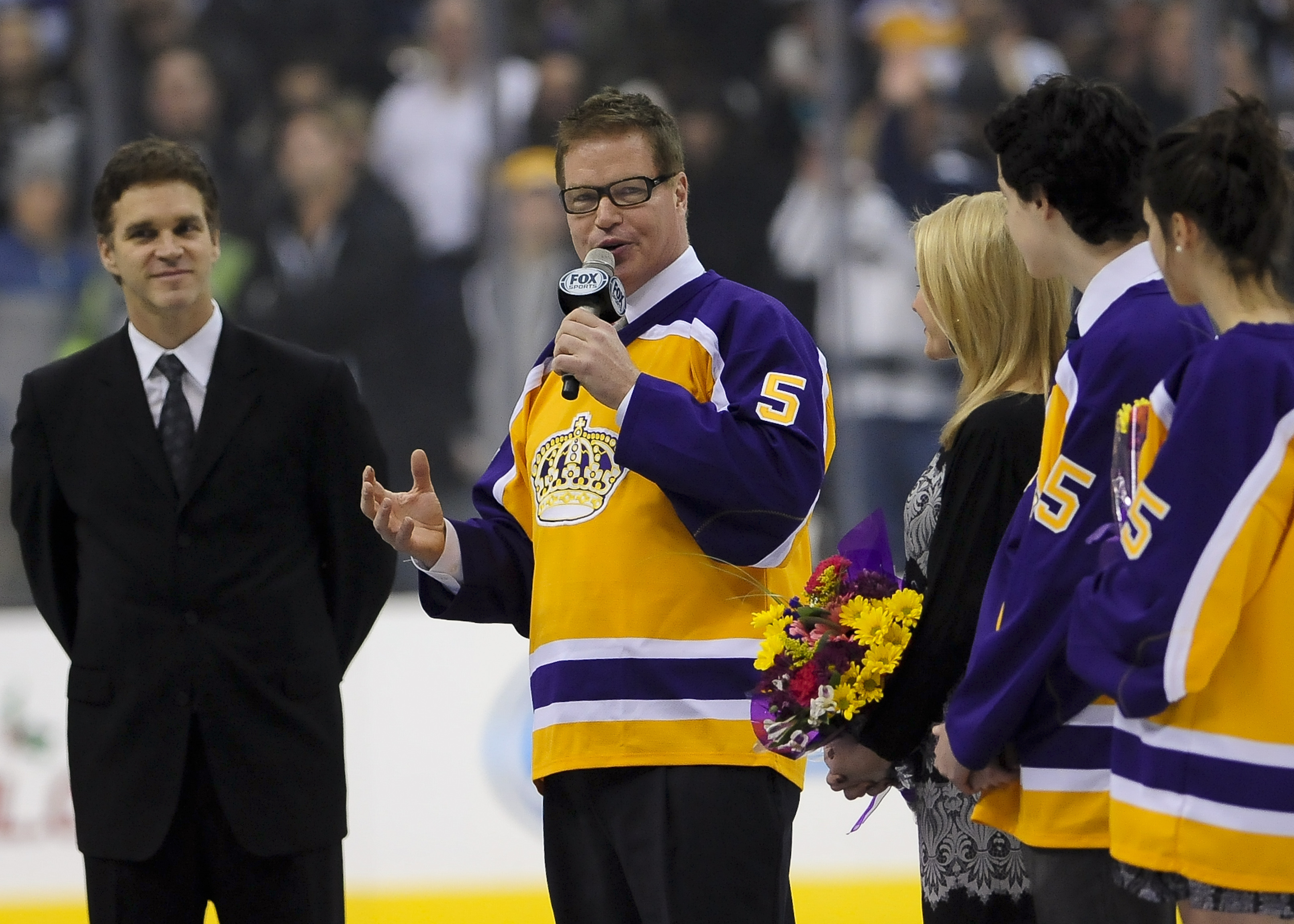 FILE - Hockey Hall of Fame and a four-time Stanley Cup winner Larry Murphy is honored before the start of an NHL hockey game between the Los Angeles Kings and the New York Islanders, Saturday, Dec. 7, 2013, in Los Angeles. When the NHL implemented 3-on-3 play in overtime nearly a decade ago, the idea was to see the most speed and skill hockey had to offer. In recent years, 3 on 3 has slowed down. Larry Murphy coaches a 3ICE team and believes the NHL should adopt the over-and-back rule.