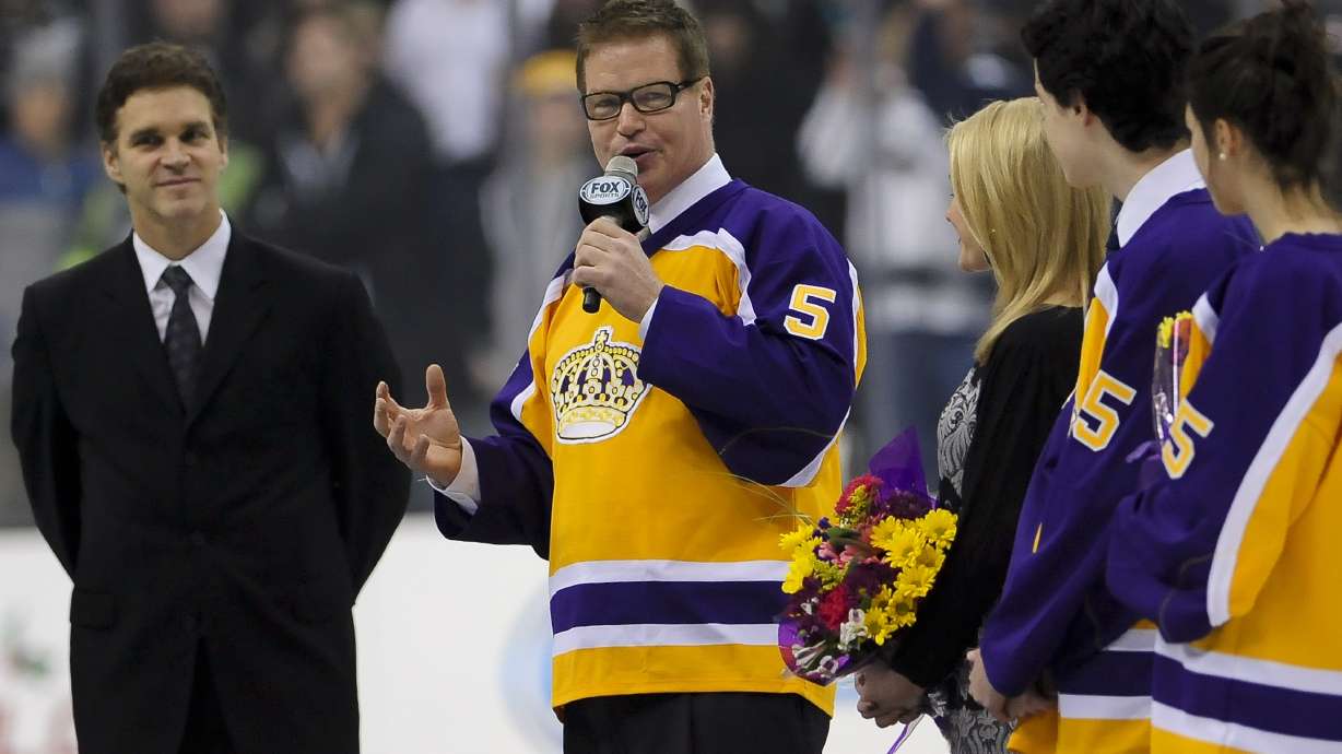 FILE - Hockey Hall of Fame and a four-time Stanley Cup winner Larry Murphy is honored before the start of an NHL hockey game between the Los Angeles Kings and the New York Islanders, Saturday, Dec. 7, 2013, in Los Angeles. When the NHL implemented 3-on-3 play in overtime nearly a decade ago, the idea was to see the most speed and skill hockey had to offer. In recent years, 3 on 3 has slowed down. Larry Murphy coaches a 3ICE team and believes the NHL should adopt the over-and-back rule.