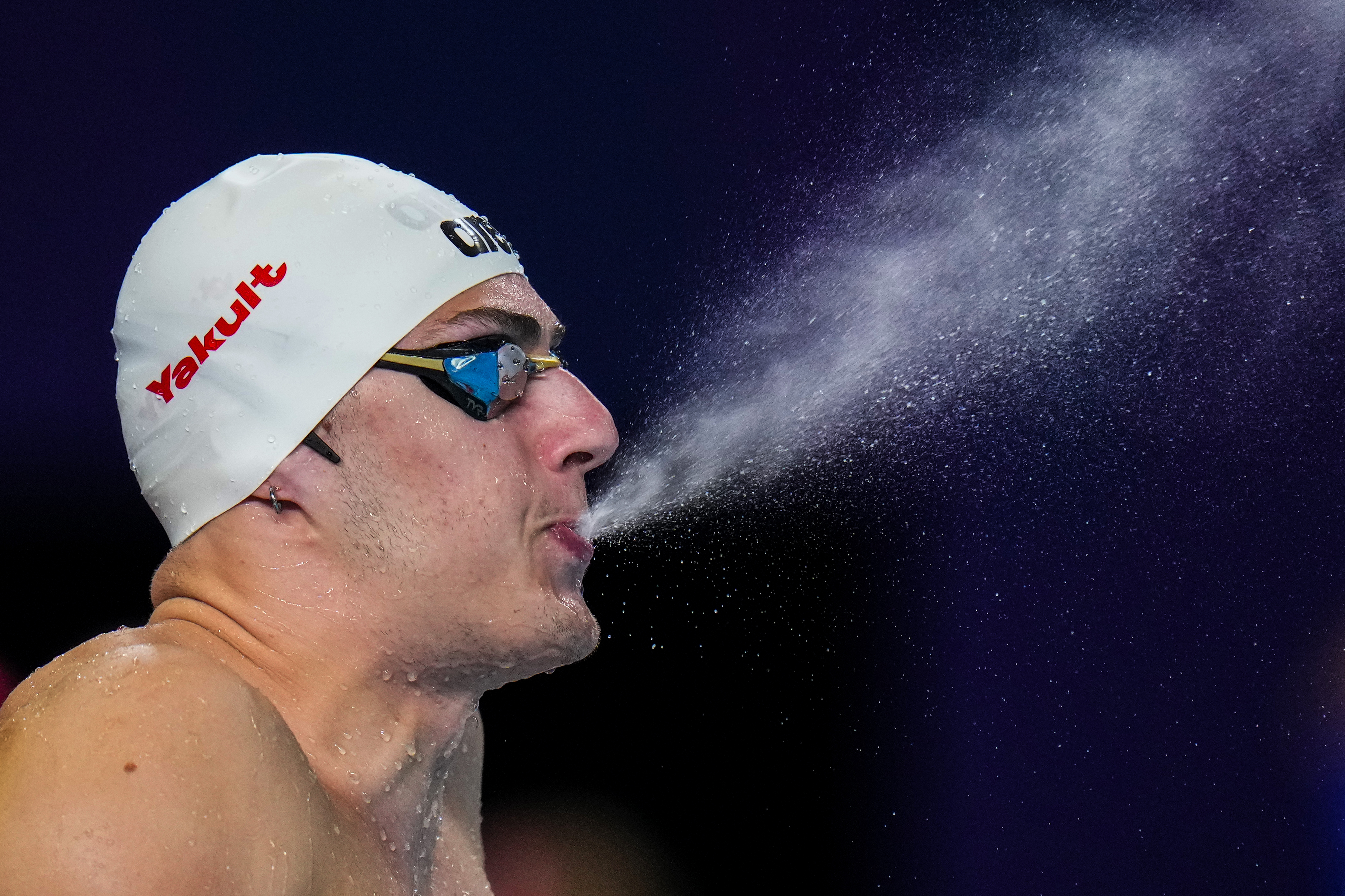 Arkadios Aspougalis of Greece sprays water as he prepares to compete in the mixed 4x100m medley heat at the World Aquatics Championships in Doha, Qatar, Wednesday, Feb. 14, 2024. 
