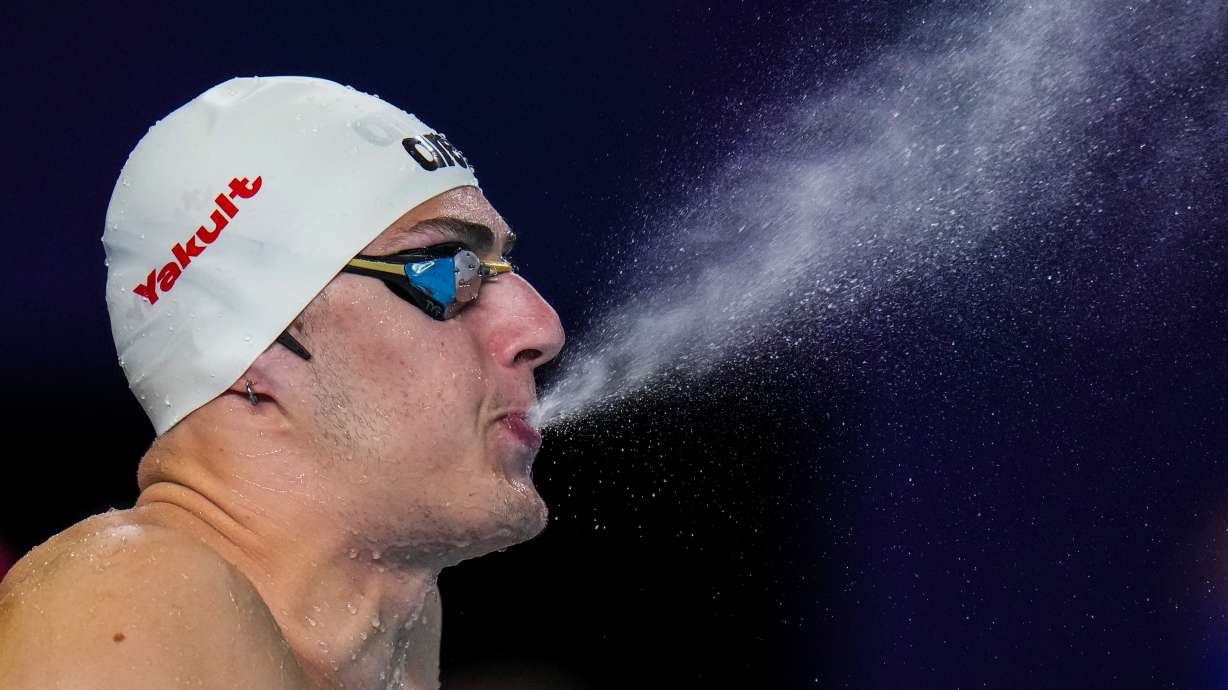 Arkadios Aspougalis of Greece sprays water as he prepares to compete in the mixed 4x100m medley heat at the World Aquatics Championships in Doha, Qatar, Wednesday, Feb. 14, 2024.