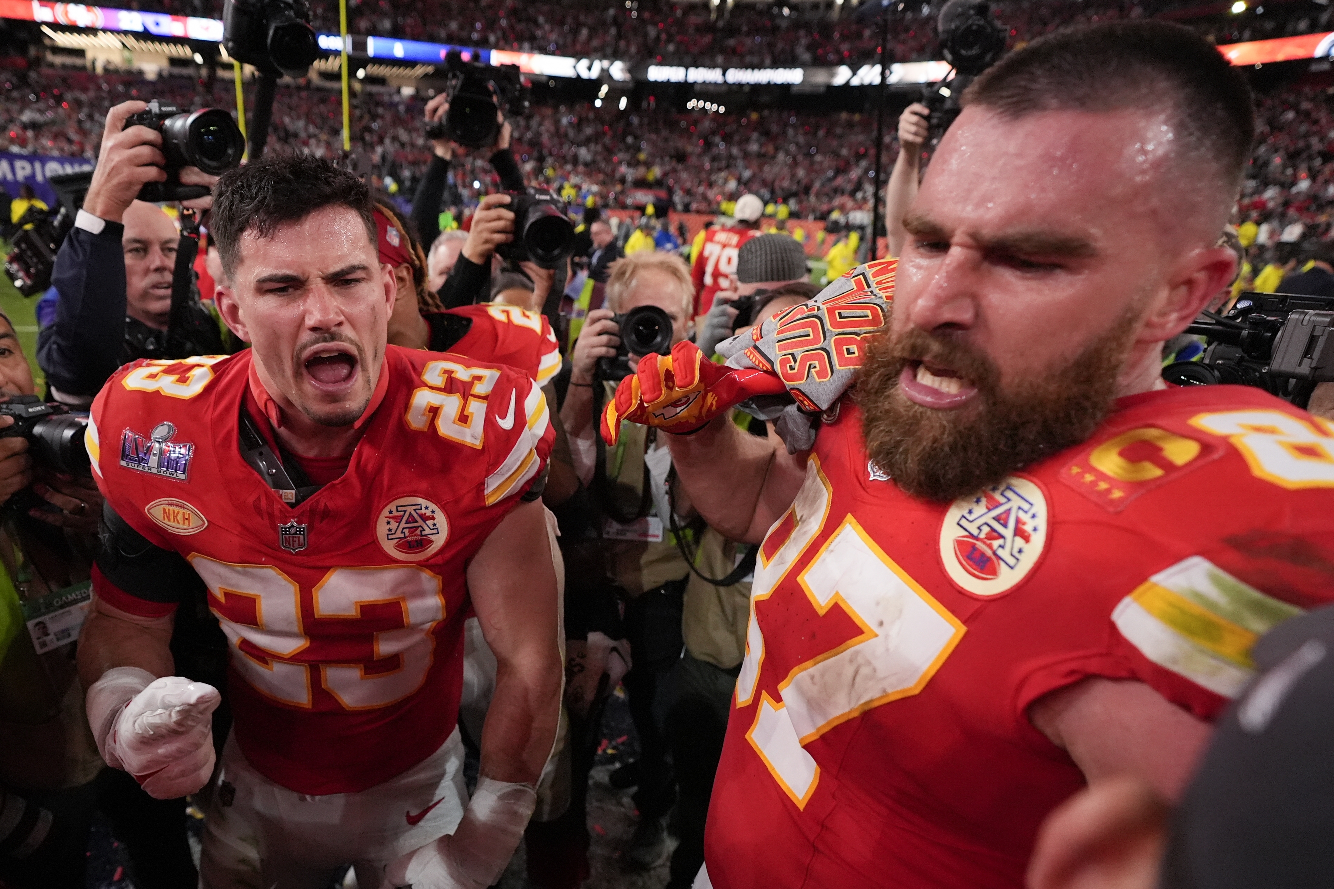 Kansas City Chiefs tight end Travis Kelce (87) and Kansas City Chiefs linebacker Drue Tranquill (23) celebrate after the NFL Super Bowl 58 football game against the San Francisco 49ers on Sunday, Feb. 11, 2024, in Las Vegas. The Kansas City Chiefs won 25-22 against the San Francisco 49ers. 