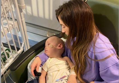 Ashley Carpenter with Maverick Carpenter, 1, at the hospital, where he's been admitted since Jan. 11. He is the youngest of triplets and has a rare autoimmune disease that causes a weakened immune system.