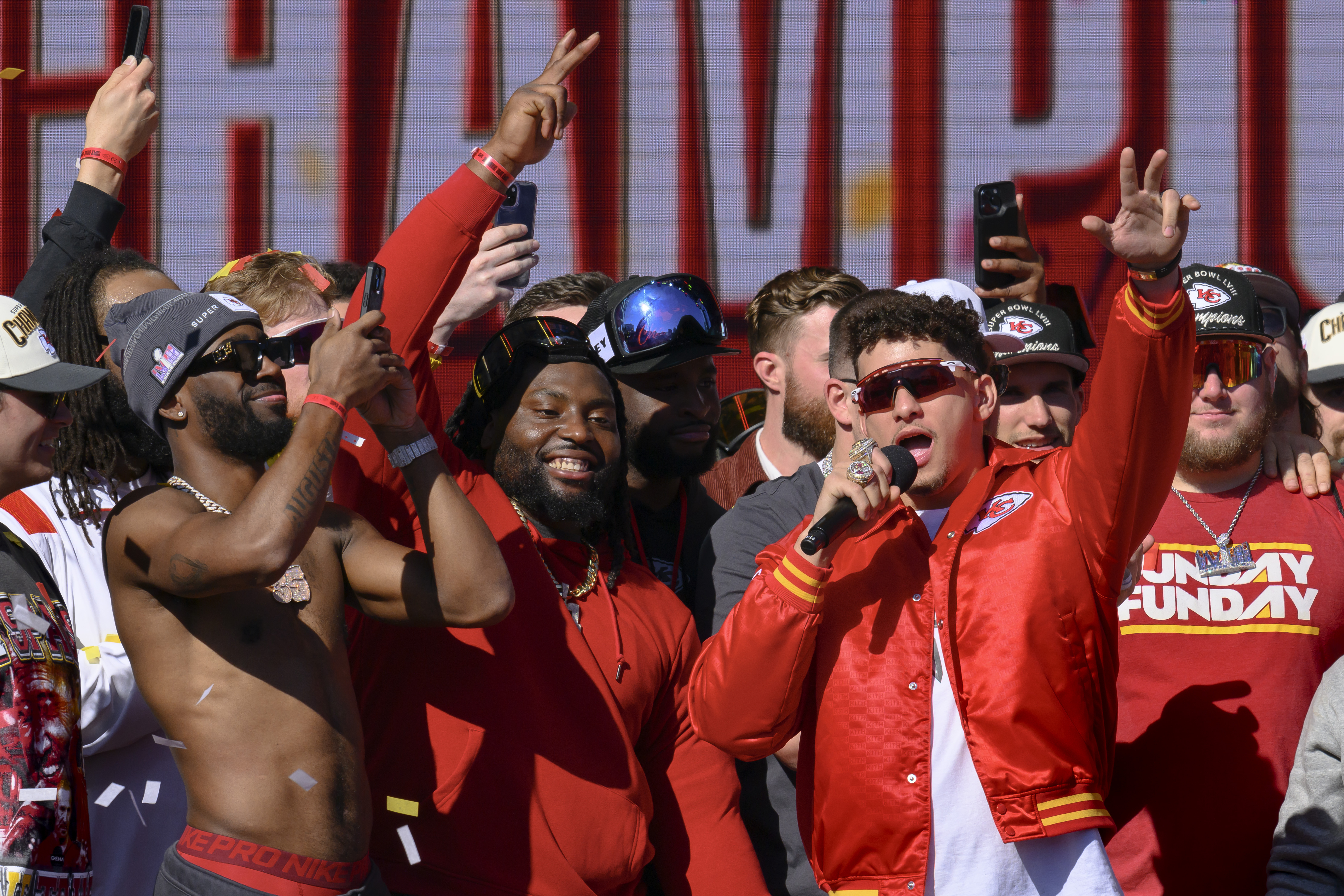 Kansas City Chiefs quarterback Patrick Mahomes, right, tells the crowd the Chiefs want to win another Super Bowl next season, during their victory rally in Kansas City, Mo., Wednesday, Feb. 14, 2024. The Chiefs defeated the San Francisco 49ers Sunday in the NFL Super Bowl 58 football game.