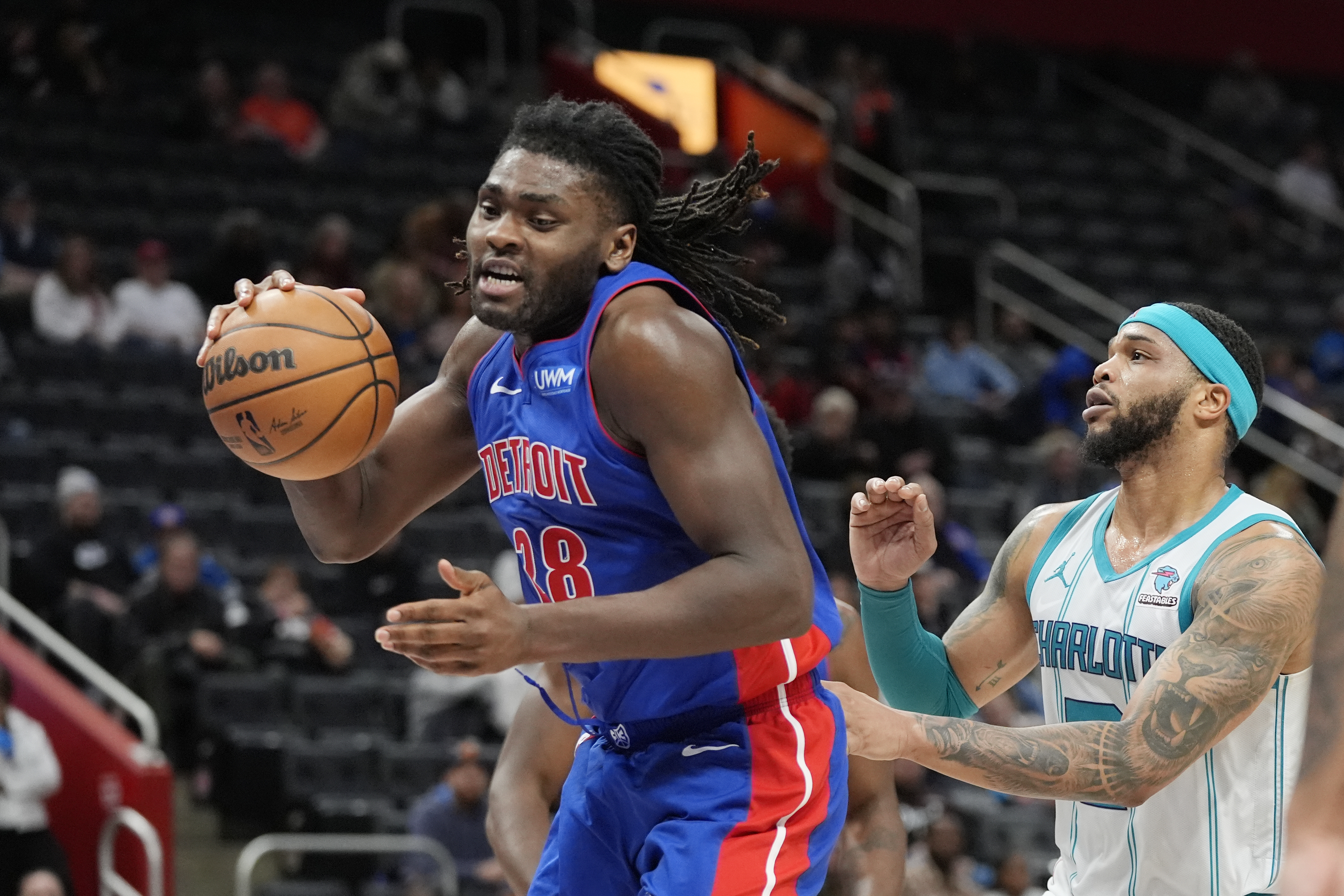 Detroit Pistons center Isaiah Stewart (28) grabs a rebound next to Charlotte Hornets forward Miles Bridges during the second half of an NBA basketball game, Wednesday, Jan. 24, 2024, in Detroit. 