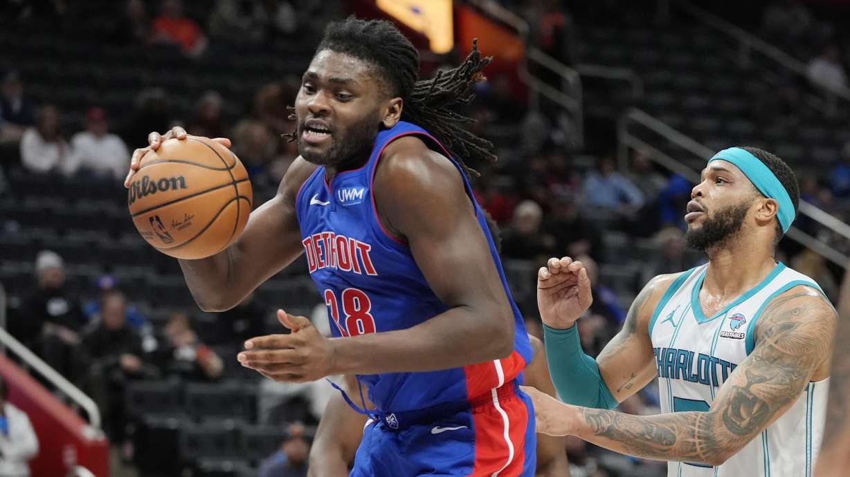 Detroit Pistons center Isaiah Stewart (28) grabs a rebound next to Charlotte Hornets forward Miles Bridges during the second half of an NBA basketball game, Wednesday, Jan. 24, 2024, in Detroit.