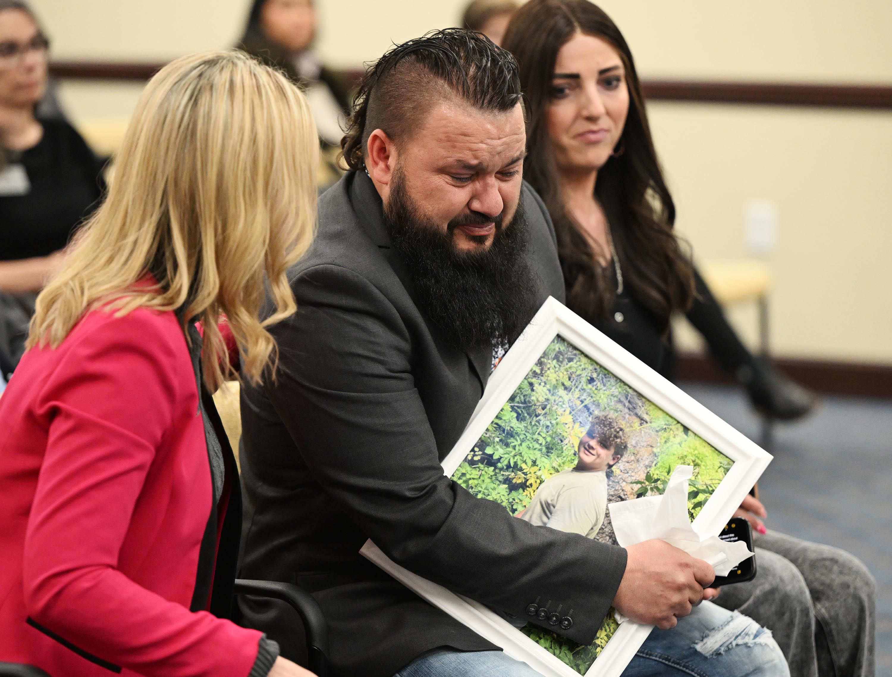 Karl Obray shows his emotion as he and his wife, Brittney Obray, take their seats after talking about their son Dexton, who died by suicide due to social media influences, during a House Judiciary Committee hearing at the Capitol in Salt Lake City on Feb. 14.