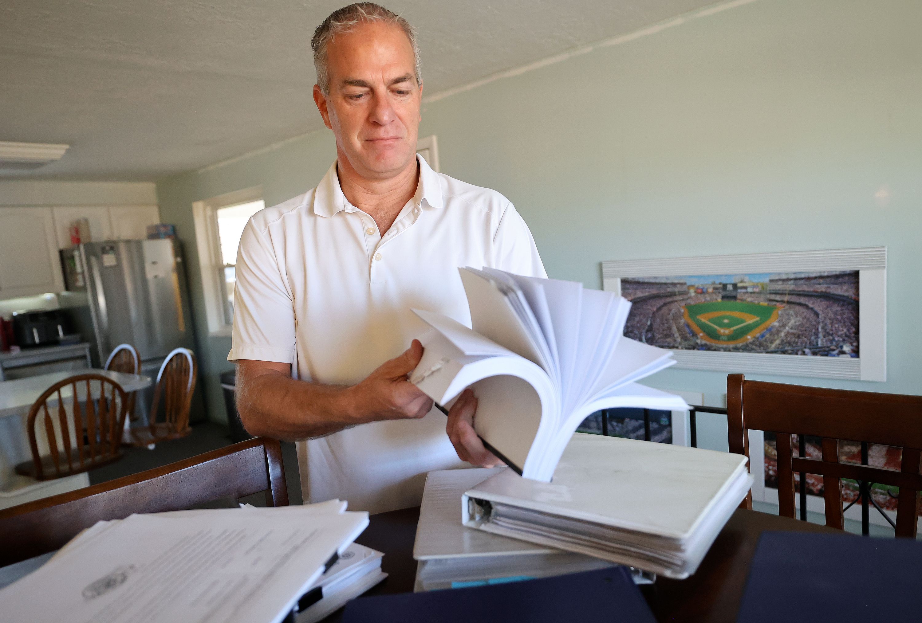 Matt Hunsaker shows a fraction of the paperwork, court files, criminal records and police reports he has related to his mother’s 1986 murder, at his home in Taylorsville on Jan. 30. He also has binders full of old newspaper articles related to Maurine Hunsaker’s case.