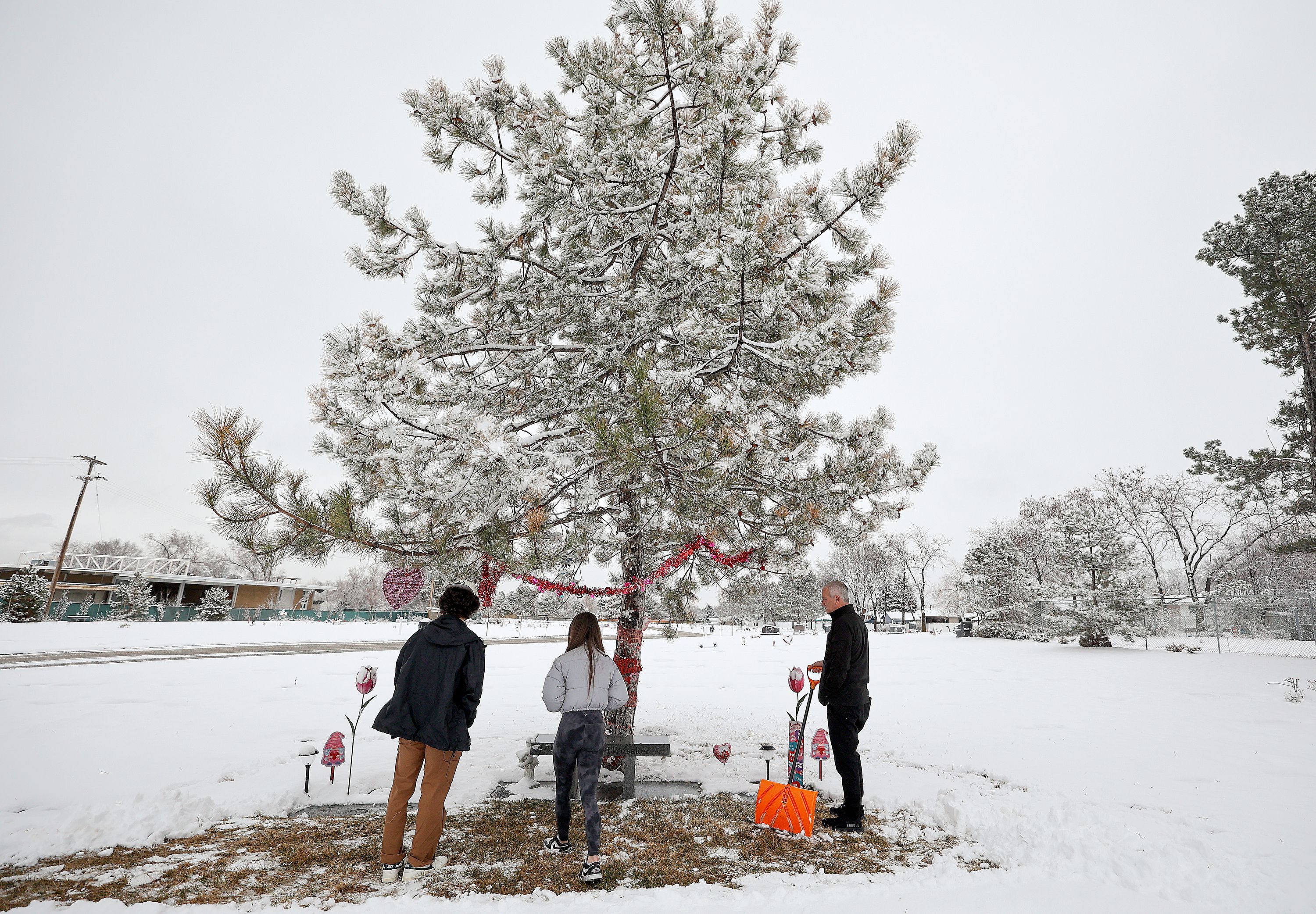 Acen Hunsaker, Hayden Hunsaker and their father Matt Hunsaker visit the grave of their grandmother and mother Maurine Hunsaker, who was murdered in 1986, at Valley View Memorial Park in West Valley City on Friday, Feb. 9.