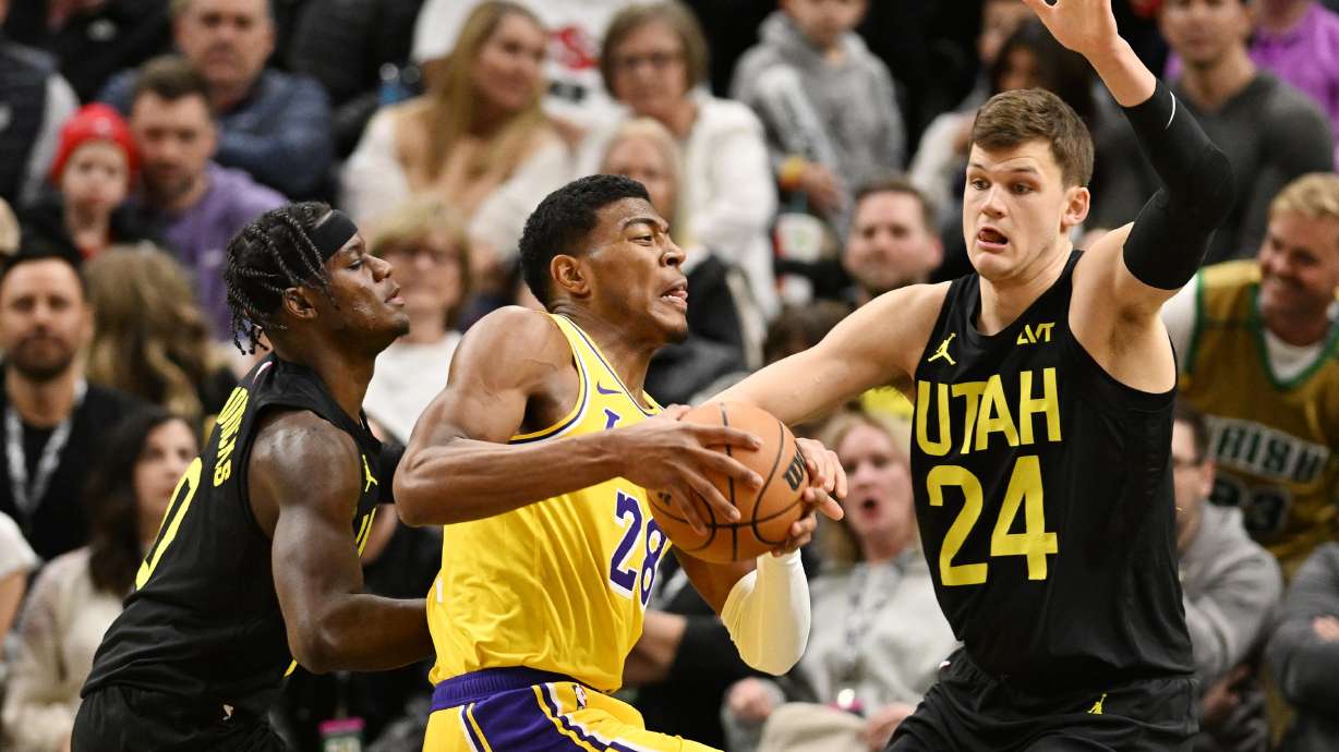 Utah Jazz forward Taylor Hendricks (0) and Utah Jazz center Walker Kessler (24) defend Los Angeles Lakers forward Rui Hachimura (28) as the Utah Jazz and the Los Angeles Lakers play at the Delta Center in Salt Lake City on Wednesday, Feb. 14, 2024.