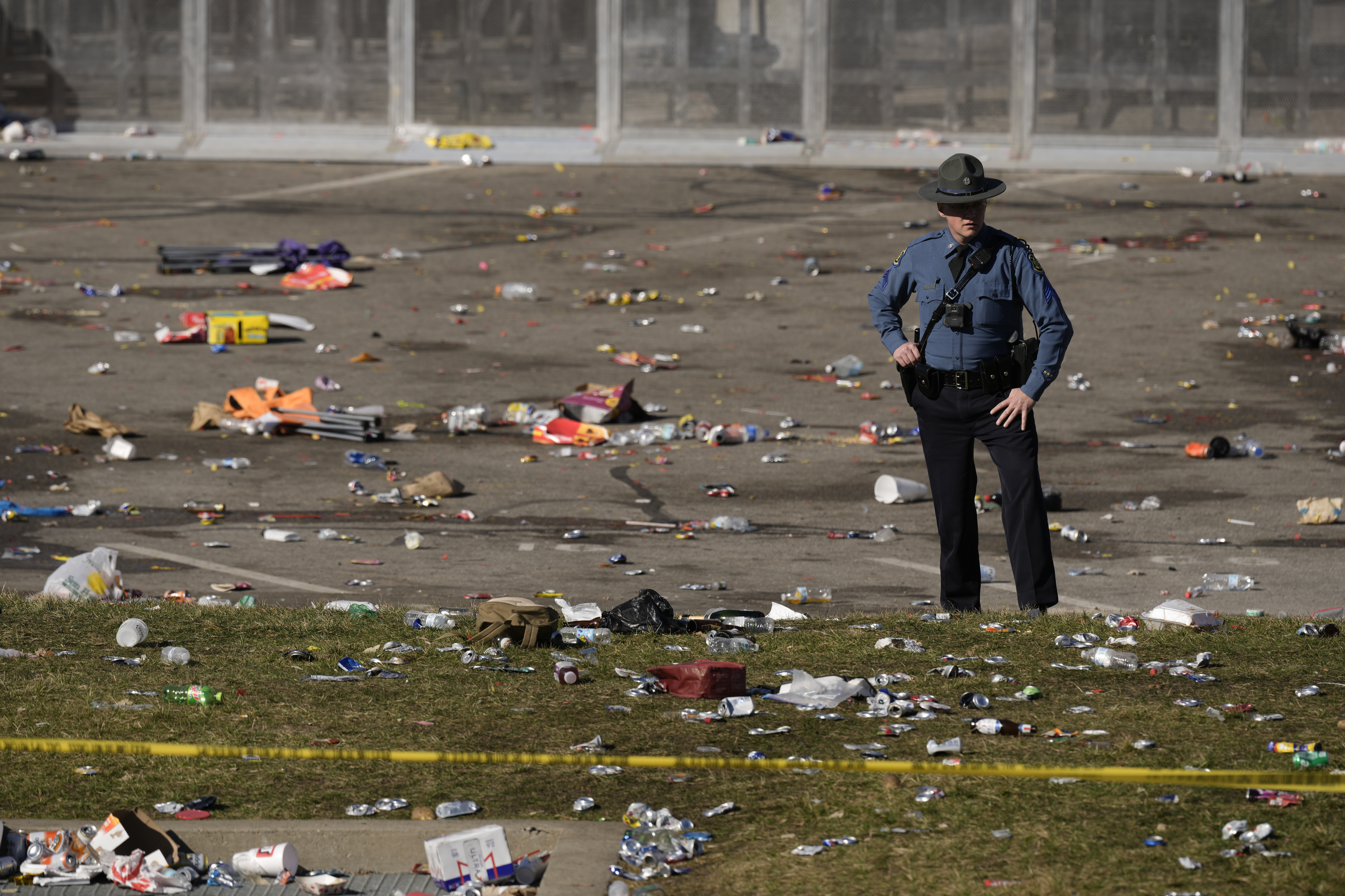A law enforcement officer looks around the scene following a shooting at the Kansas City Chiefs NFL football Super Bowl celebration in Kansas City, Mo., Wednesday, Feb. 14, 2024. Multiple people were injured, a fire official said.