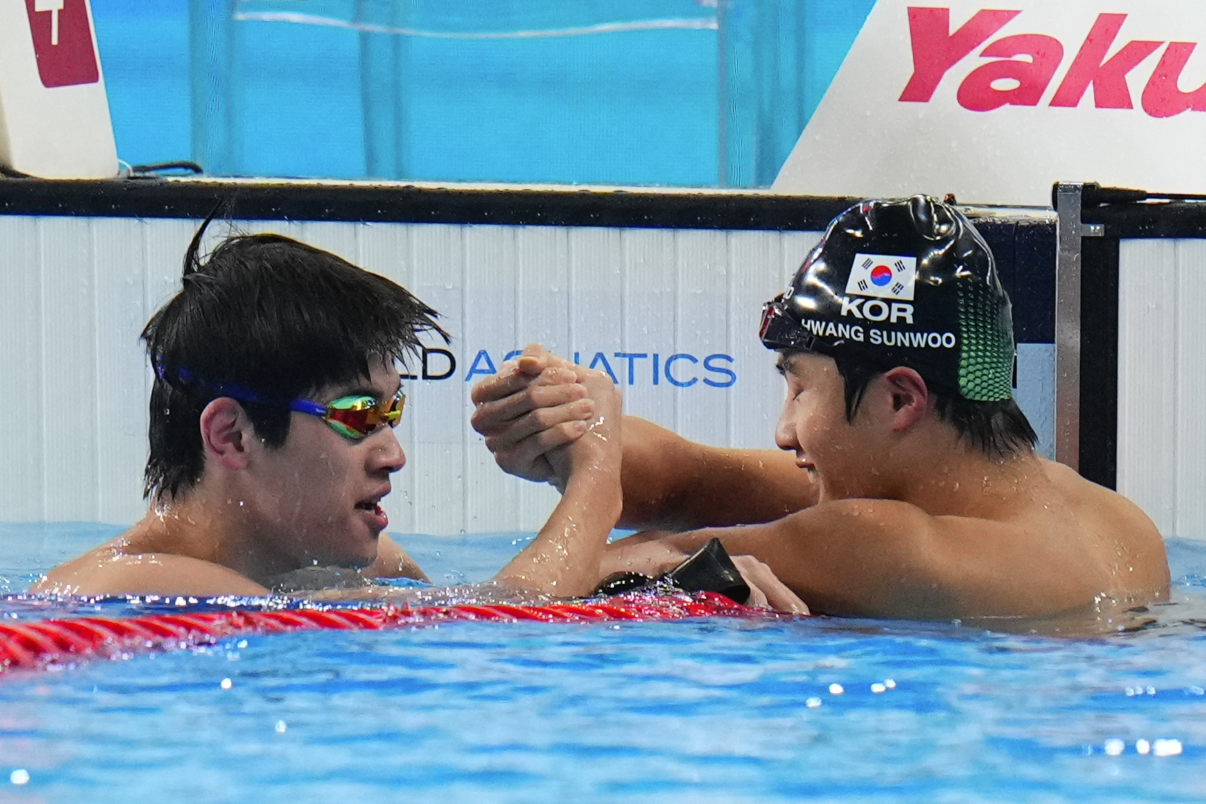 Zhanle Pan of China , left, compliments Hwang Sun-woo of South Korea after Pan won in the men's 100-meter freestyle final at the World Aquatics Championships in Doha, Qatar, Thursday, Feb. 15, 2024. 