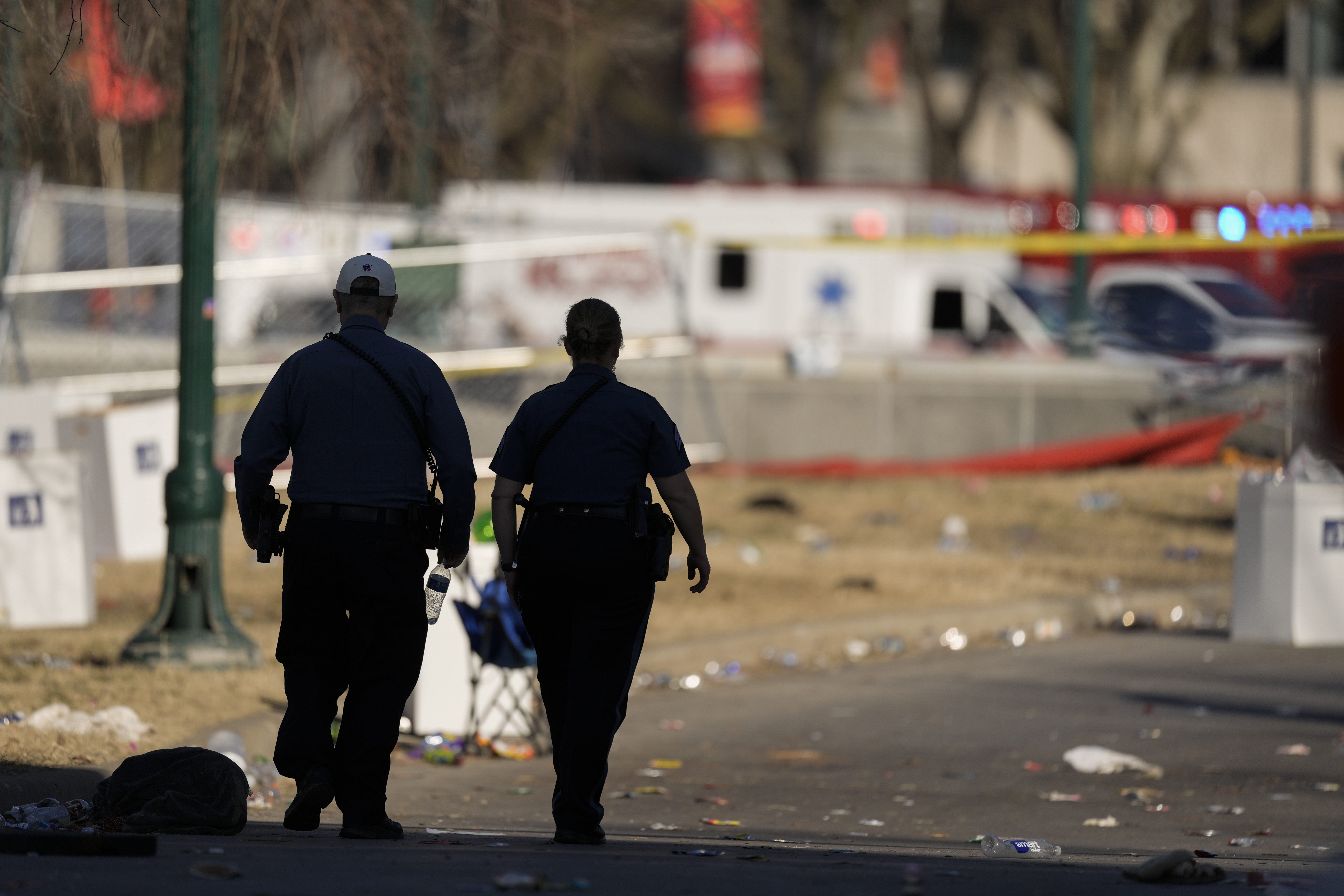Emergency medical technicians walk around the scene after an incident following the Kansas City Chiefs victory parade in Kansas City, Mo., Wednesday. Police say the shooting after the parade appeared to stem from a dispute between several people.