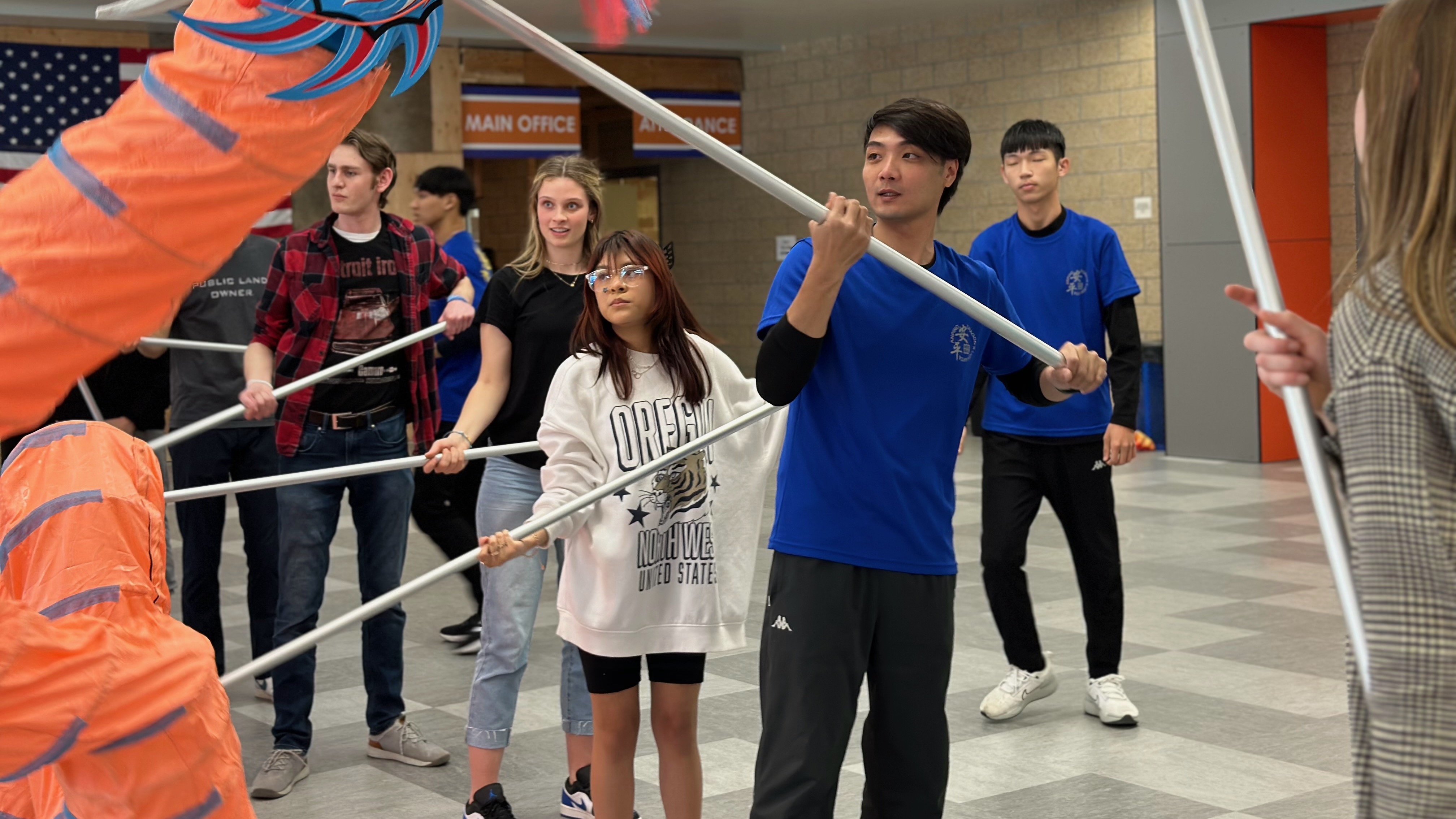 Chung-Hsuan Huang of the An-Ping Sword, Lion and Drum Team of Taiwan offers instruction in the dragon dance to students at Timpview High School in Provo. The Provo-based Su Ma Ma Chinese Club hosted the An-Ping group, which gives the last performance of its Utah visit on Friday at Timpview High School.